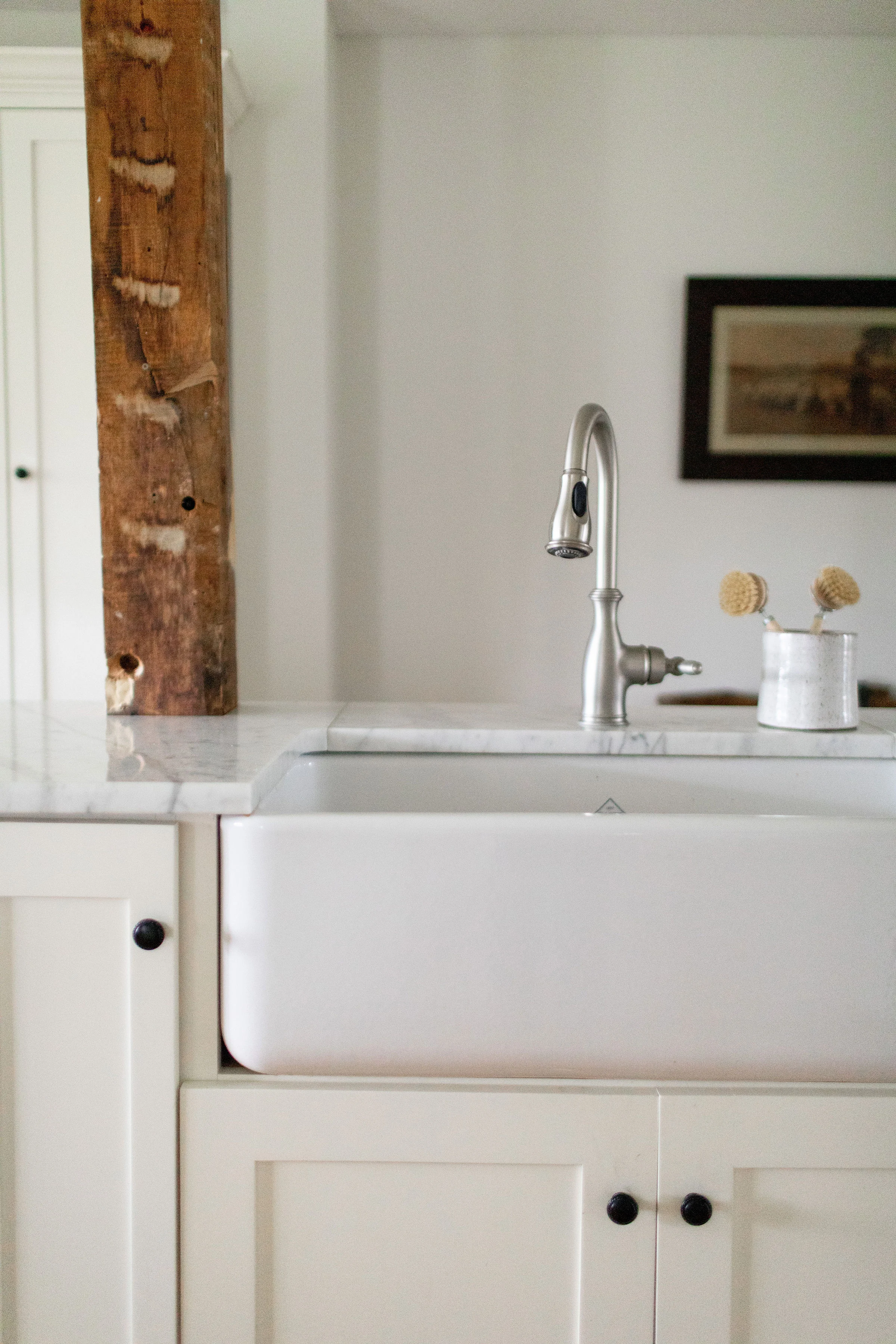 White kitchen with wood beam NY interior designer