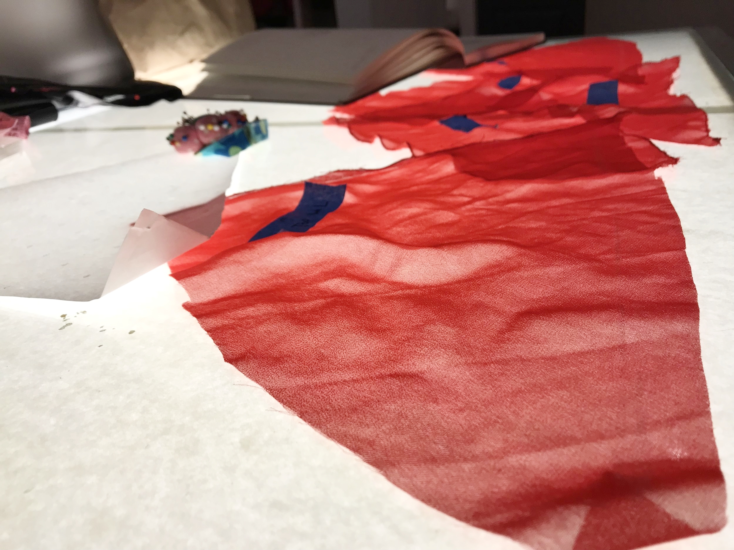 Patterns for a red sheer dress, one of the garments in Hidalgo's upcoming collection.