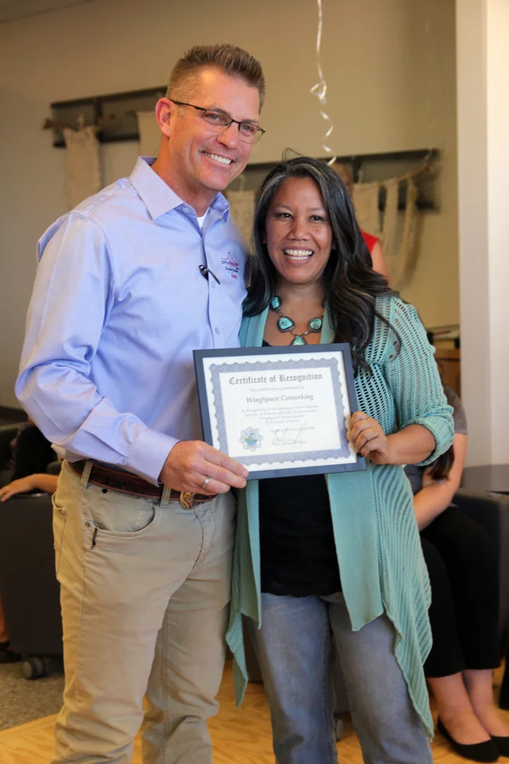 Mayor Greg Mengarelli presents Melanie Banayat with a Certificate of Recognition. The City of Prescott Declares June 7th at WingSpace Coworking Day in Prescott, Arizona.