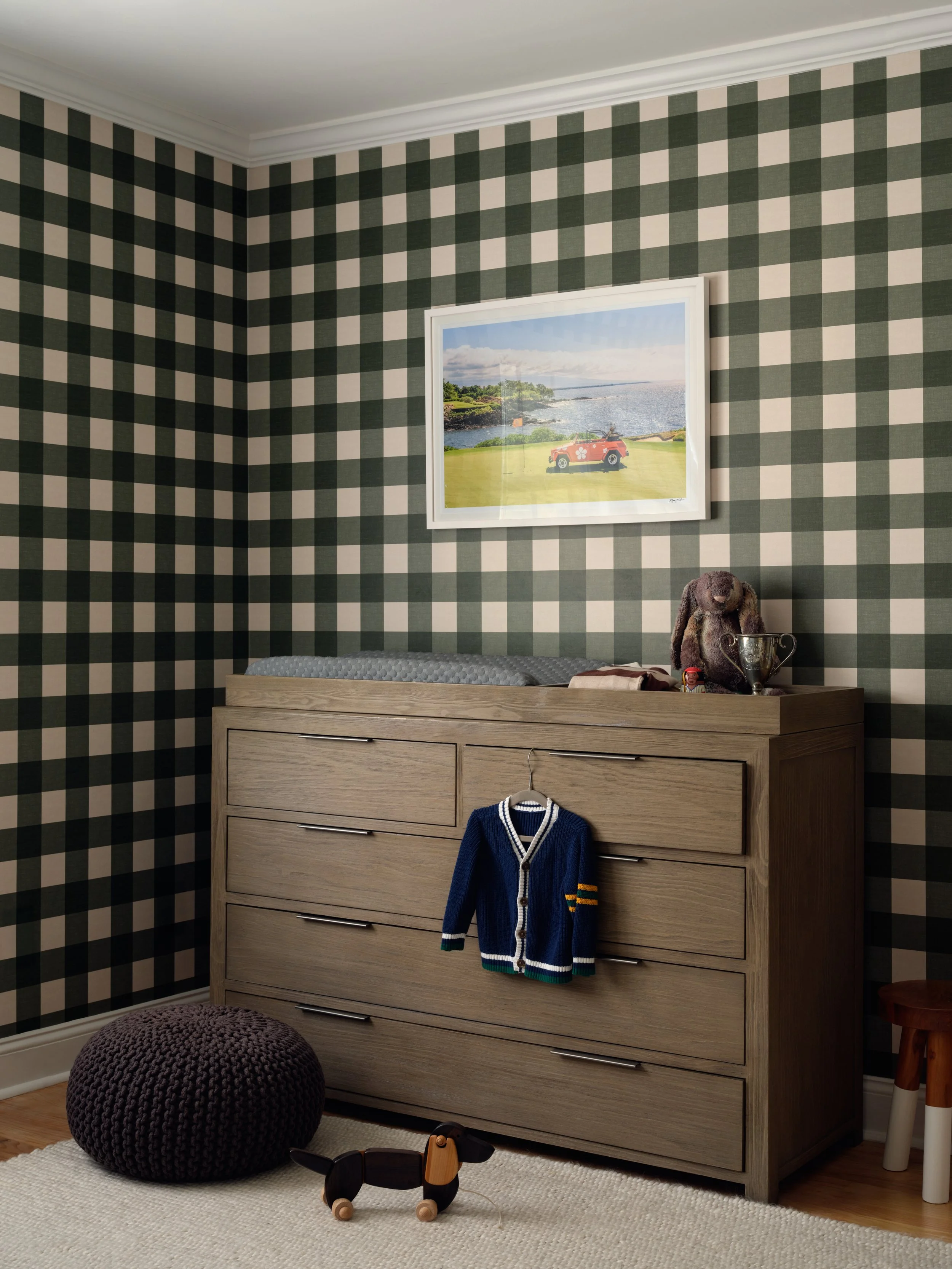 Dresser and changing table in the Bedford nursery with green checkered wallpaper and framed beach print