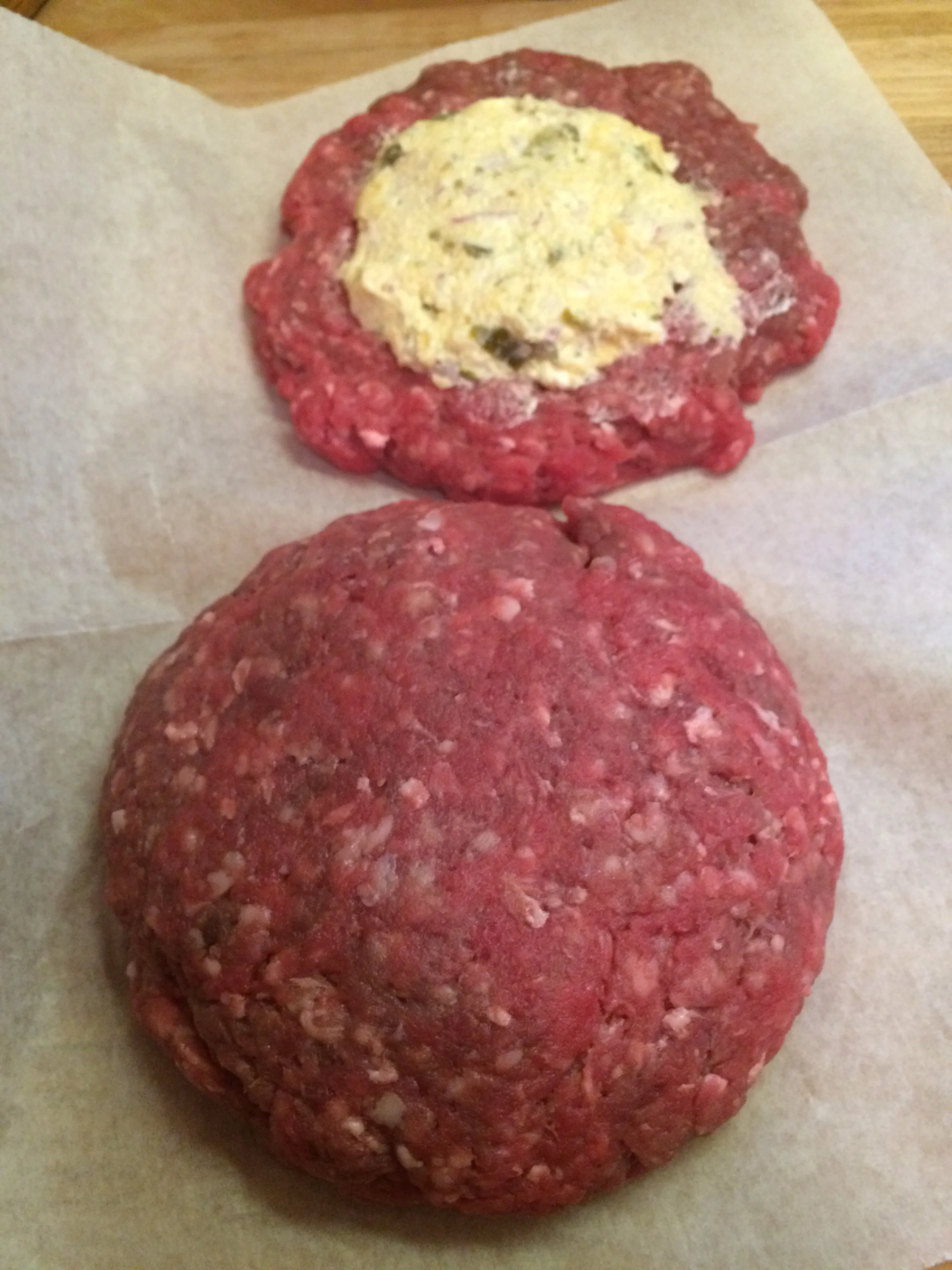 Seal the edges and reshape the burger. Sprinkle with salt and pepper before putting on the grill