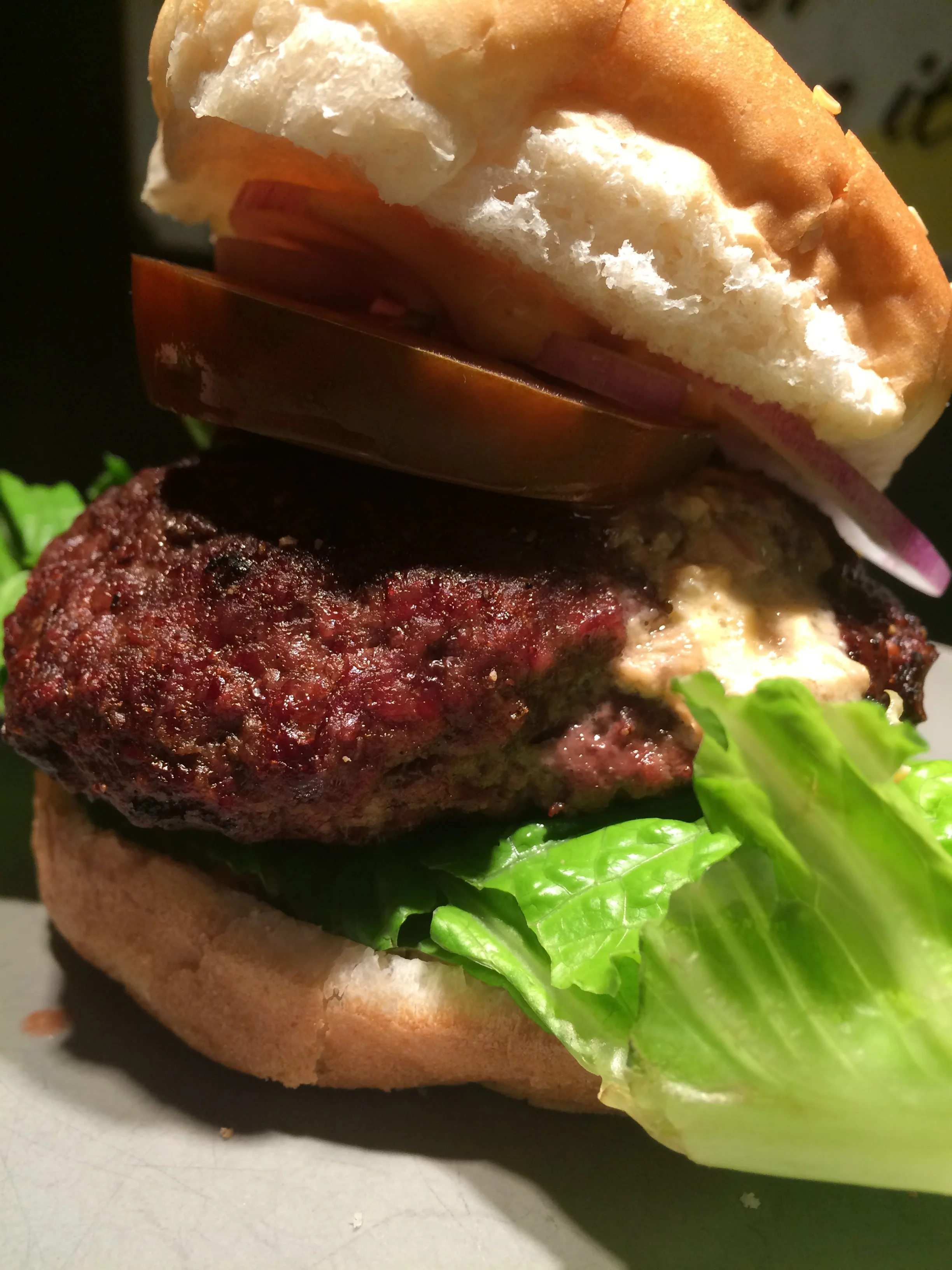And here is your finished grilled burger. Place some sriracha sauce on the bottom bun then add lettuce, burger, choice of toppings and more sauce on the top bun to hold. Cut it 1/2 for serving. The center will be a creamy, cheesy and spicy burst of flavor.