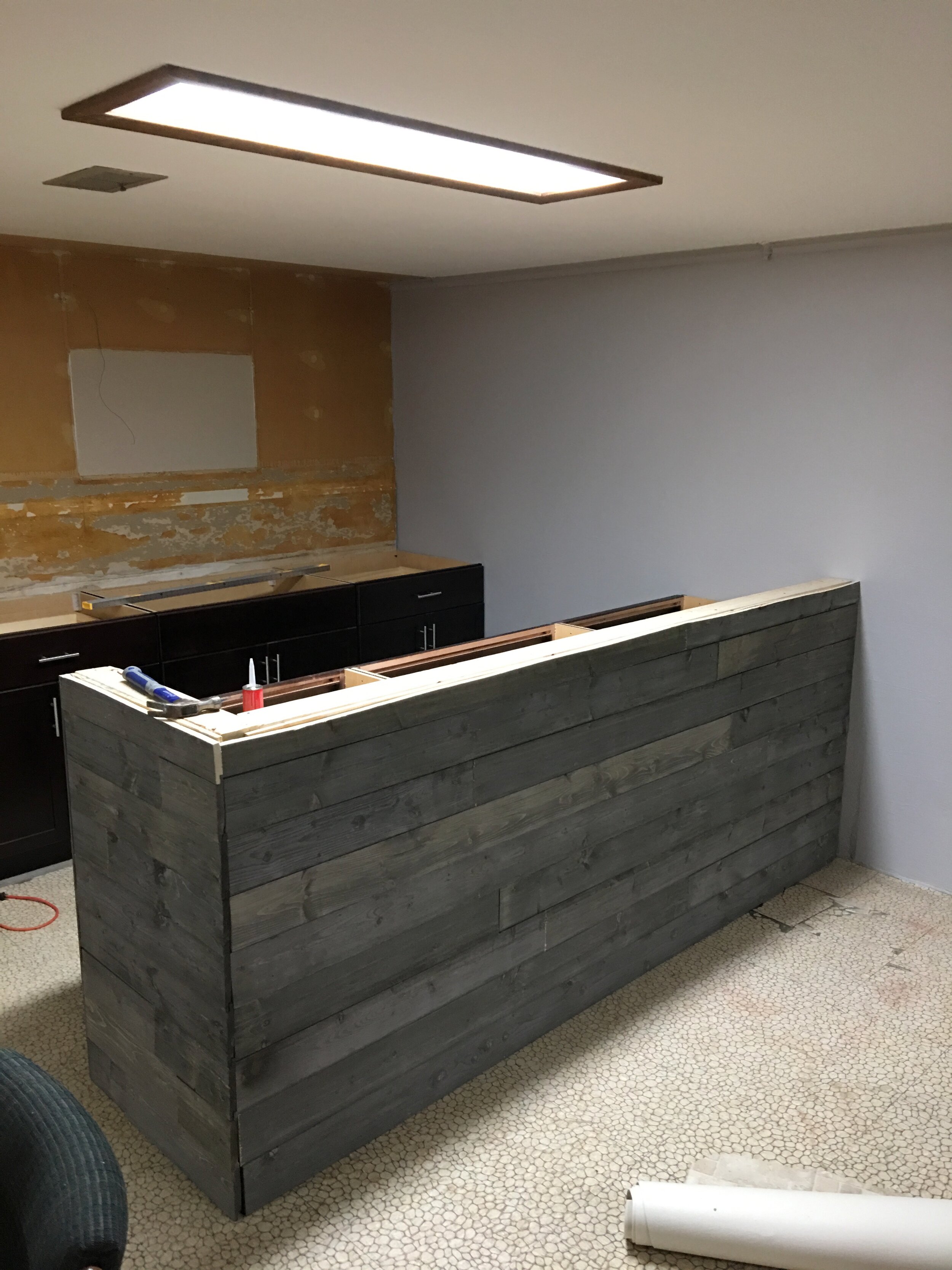 Back at the bar I screwed in some barn wood that I purchased from Home Depot.