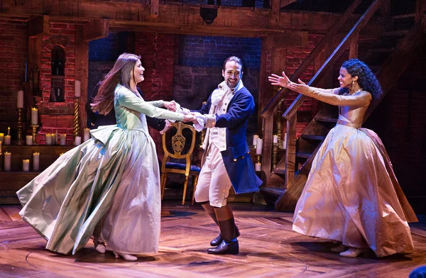 L-R: Phillipa Soo (Eliza Hamilton), Lin-Manuel Miranda (Alexander Hamilton), and Renee Elise Goldsberry (Angelica Schulyer Church) in Hamilton. 