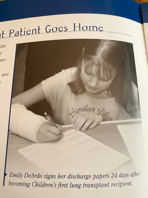 Emily signing discharge papers after becoming Nationwide Children's Hospital's first lung transplant recipient.