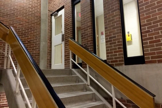 Exit the stairwell on the second floor, and turn left. By passing through the door on the left, you are leaving Humphrey Hall and entering the Craine Building.