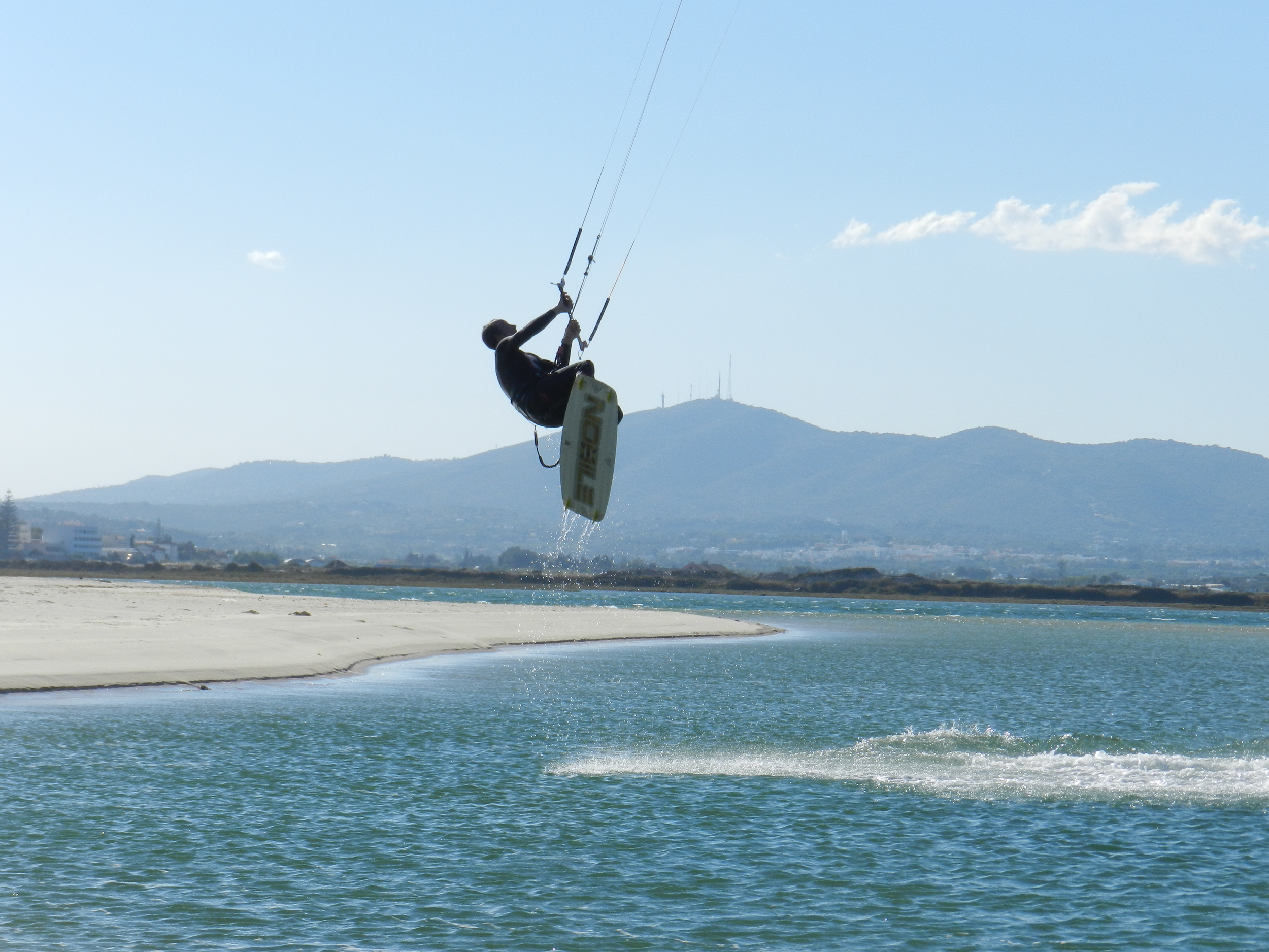 Kitesurfer getting some air in the Fuseta lagoon 
