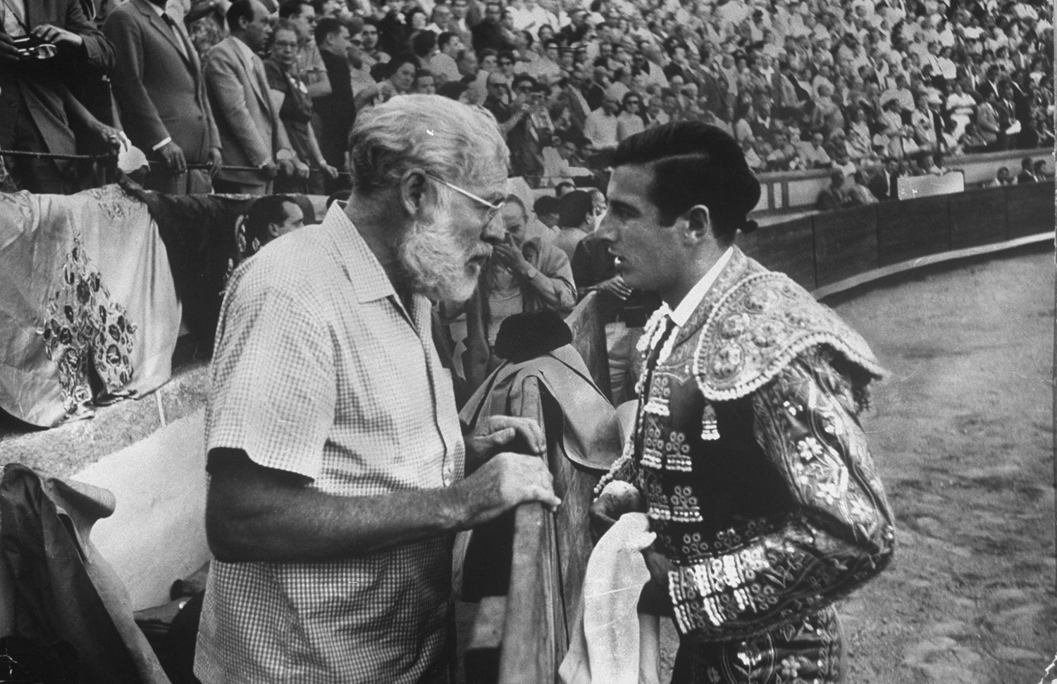 Spanish matador Antonio Ordóñez getting a pep talk from long time friend Ernest Hemingway before a bullfight in 1959. If Hemingway gave Ordóñez the same advice he gave friend A.E. Hotchner the day Hotchner became a matador , it went something like this: "You only have to do three things. Number one: Look tragic... Number two: when you get to the ring, people are watching you. Don't lean on anything; it's ugly for the suit. And number three: if the photographers come toward you, put your right foot forward; it's sexier."