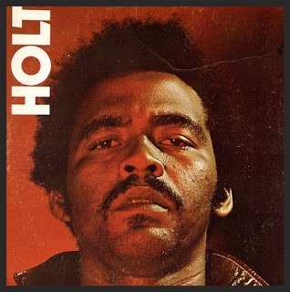 Jamaican reggae singer John Holt, whose original “I’ve Got To Get Away” was the basis for Massive Attack’s cover of the song. Visit his Wikipedia entry.