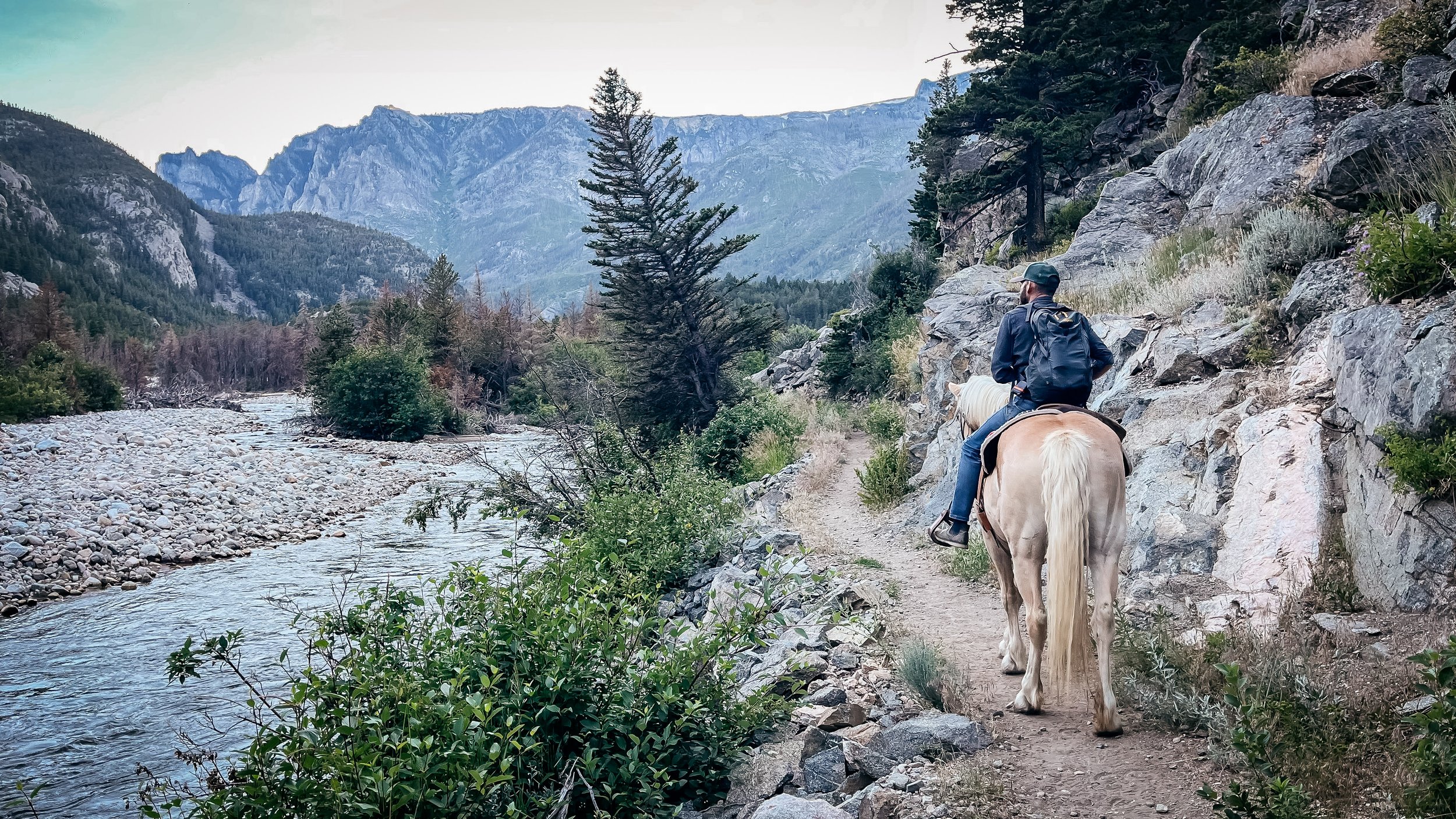 Trevor Hooper, man, riding a horse in the summer in Utah.