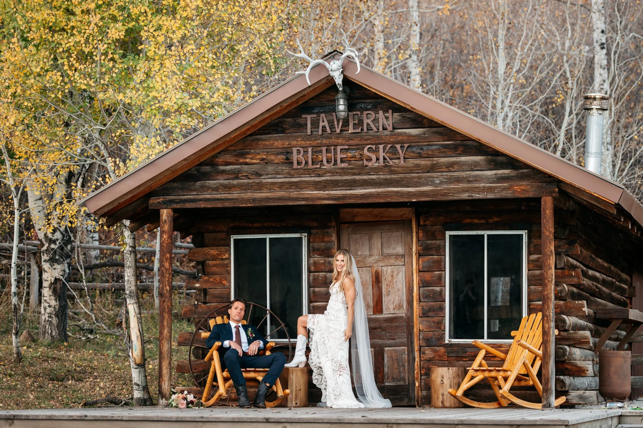 Blue Sky Ranch and High West Distillery fall wedding in Park City, Utah. Bride and groom portrait with fall colors in front of an old ranch cabin.