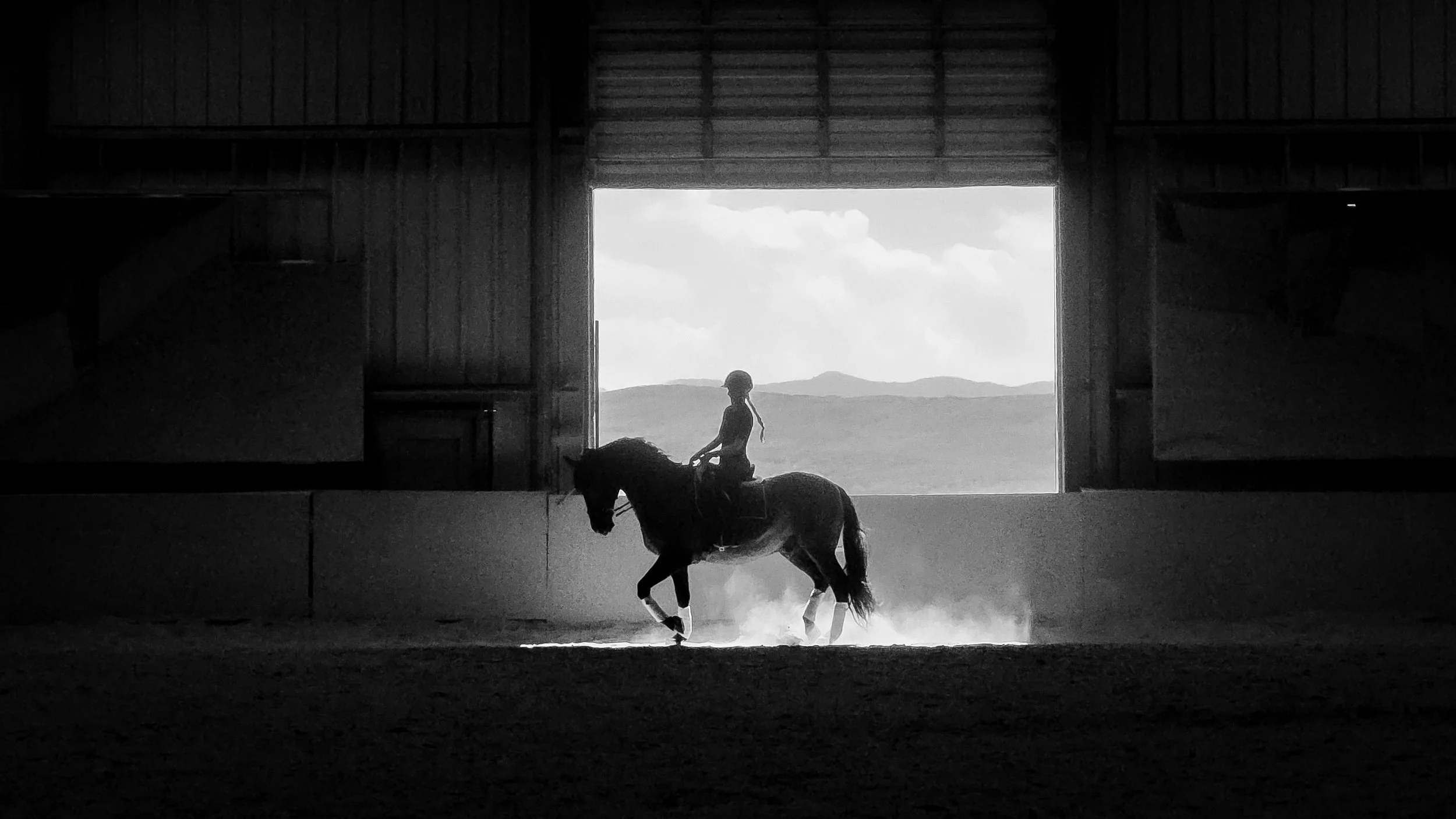 Woman riding her horse in an arena in Oakley, Utah.
