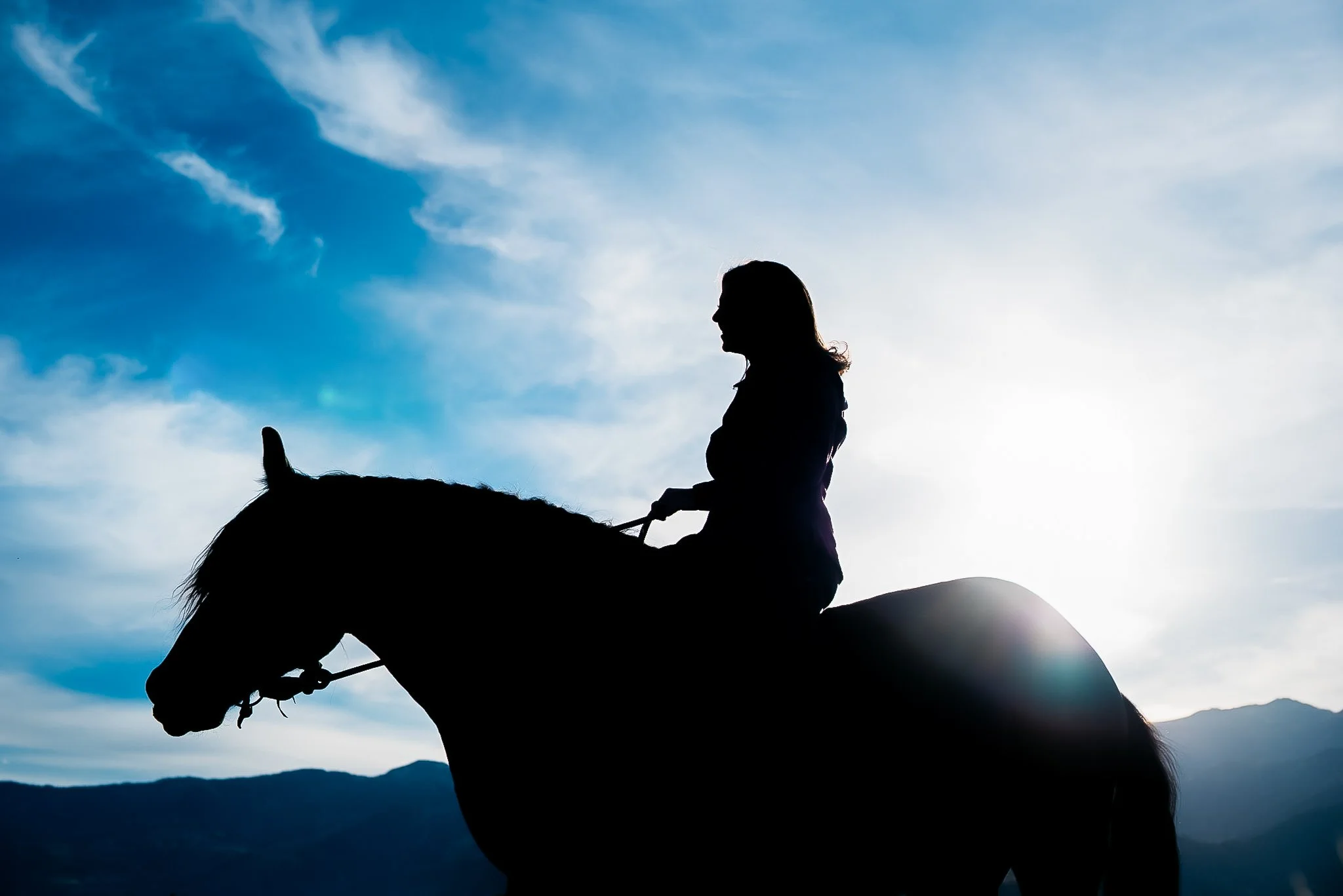 Portrait of woman riding her horse in Park City, Utah during the summer. 