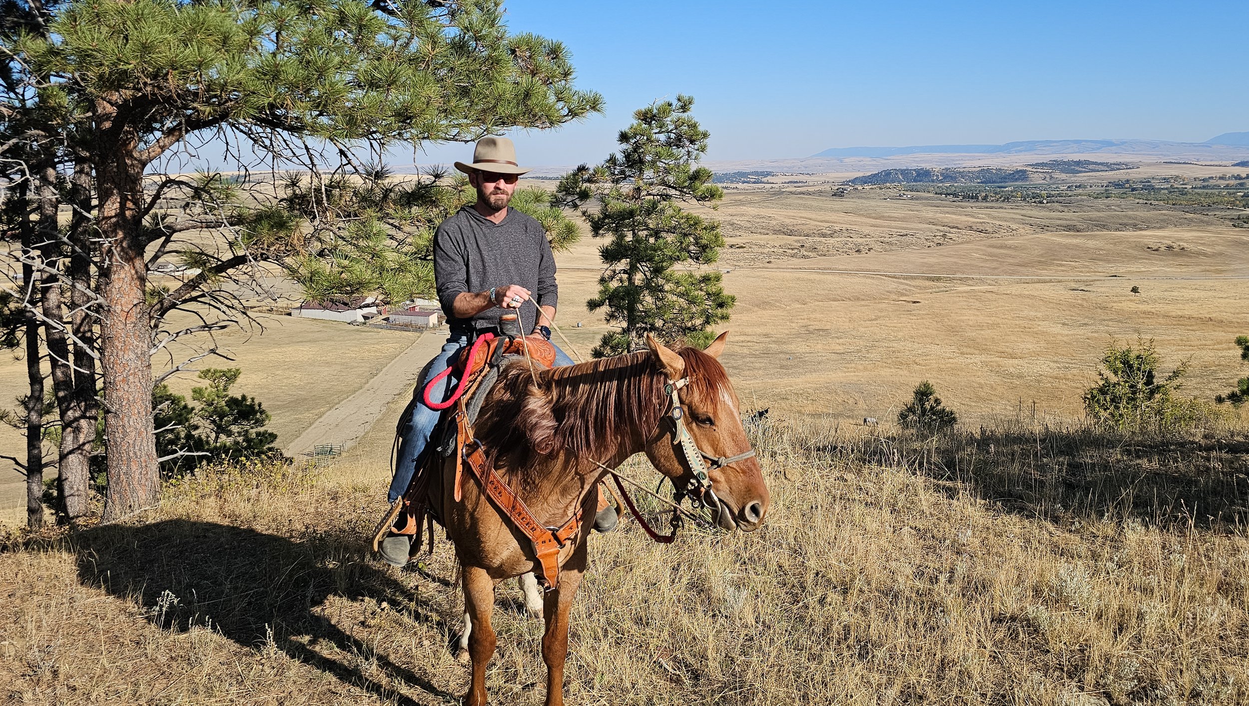 Trevor Hooper, man, riding a horse in the summer in Utah.