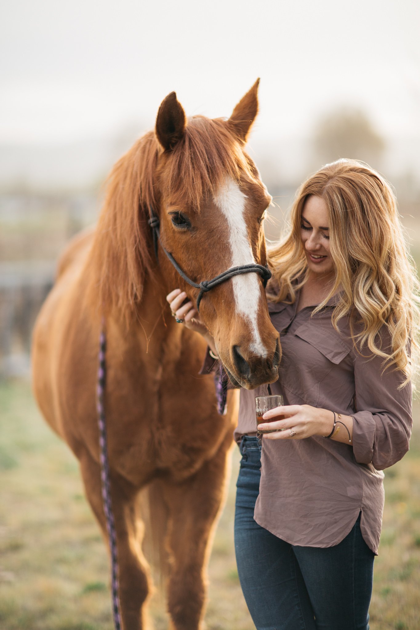 Portrait of woman with horse in Park City, Utah during the summer. 