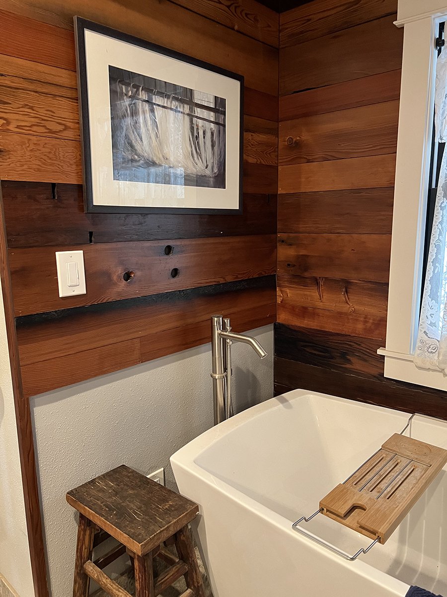 Primary suite bathroom with wood paneling reclaimed from leather dyeing vats