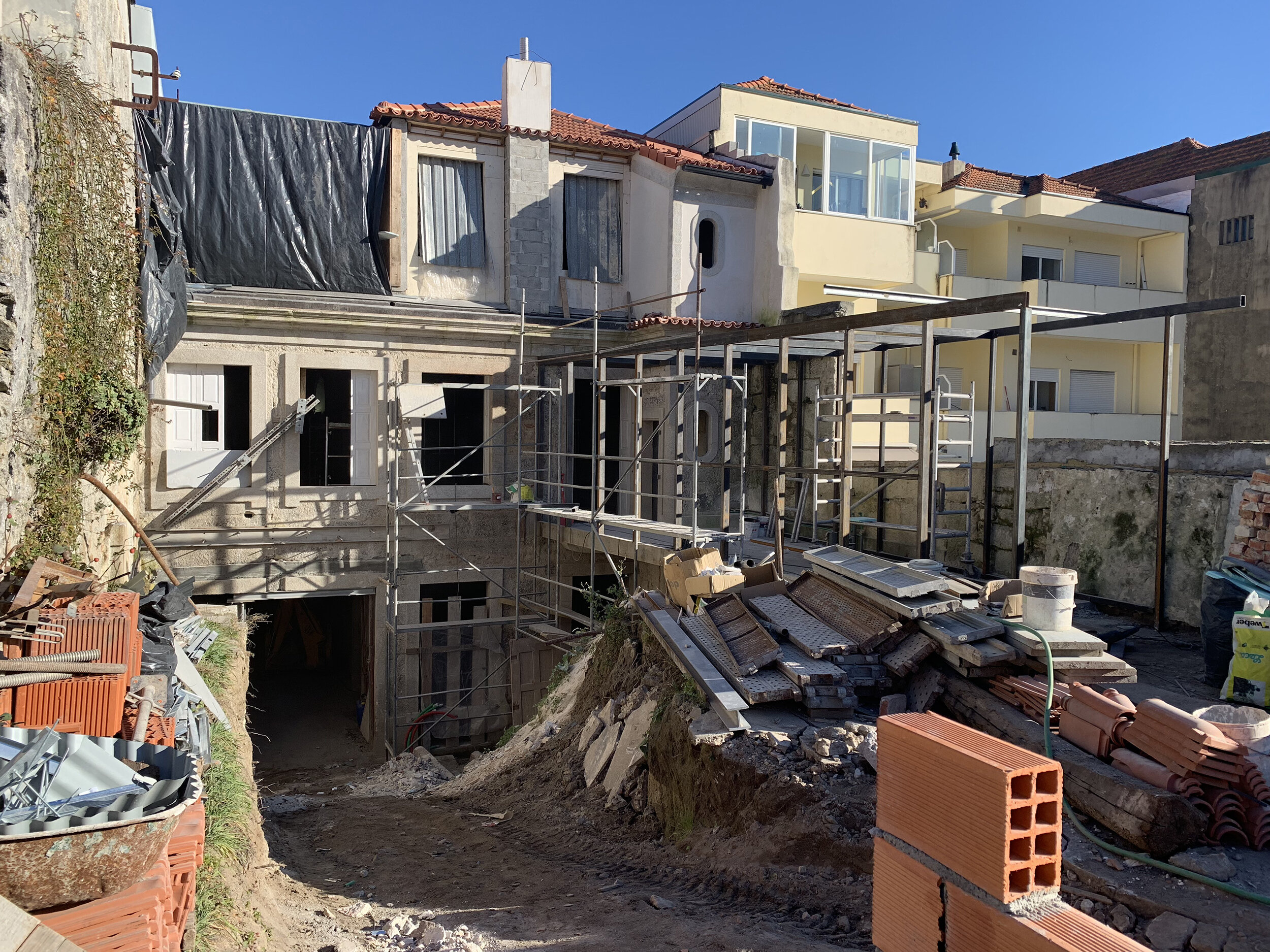 Overall view of the rear of the Almada building during construction, showing the temporary access road