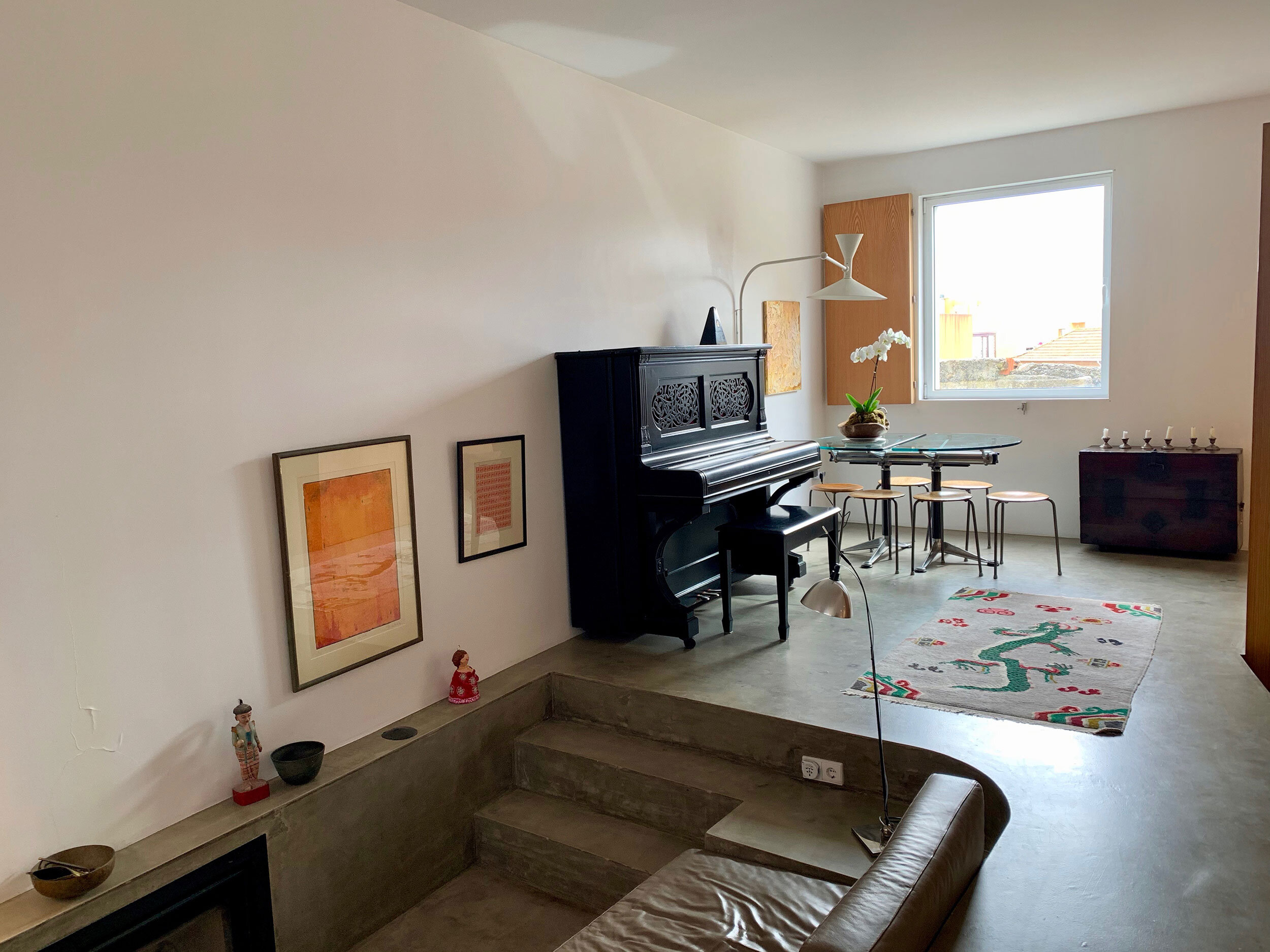 cast cement stairs to the recessed living area