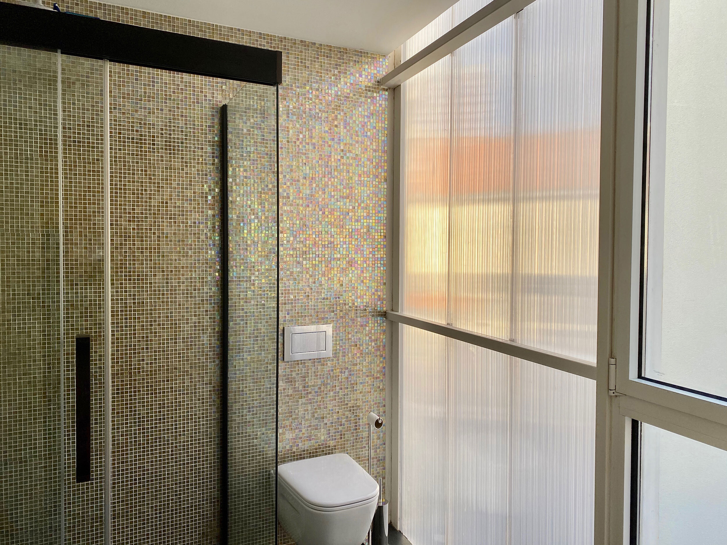 Shower with Italian glass tile and slate floors and walls that are translucent for maximum light