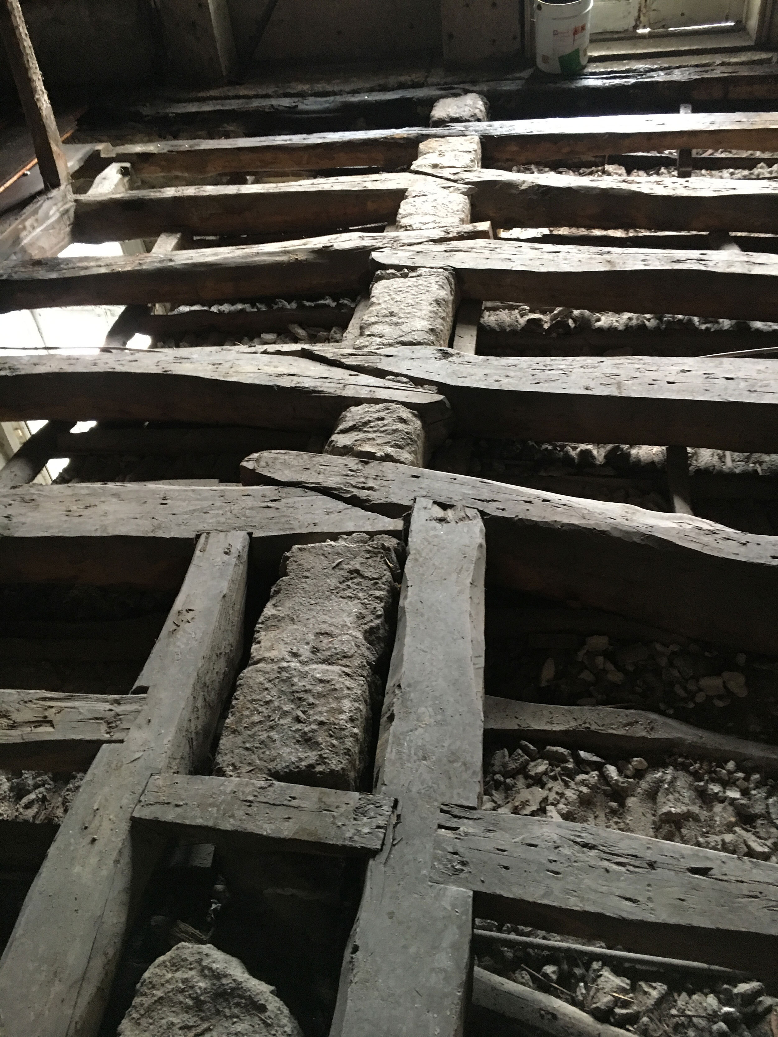 Sistering of floor joists on granite bearing wall in Apartment F