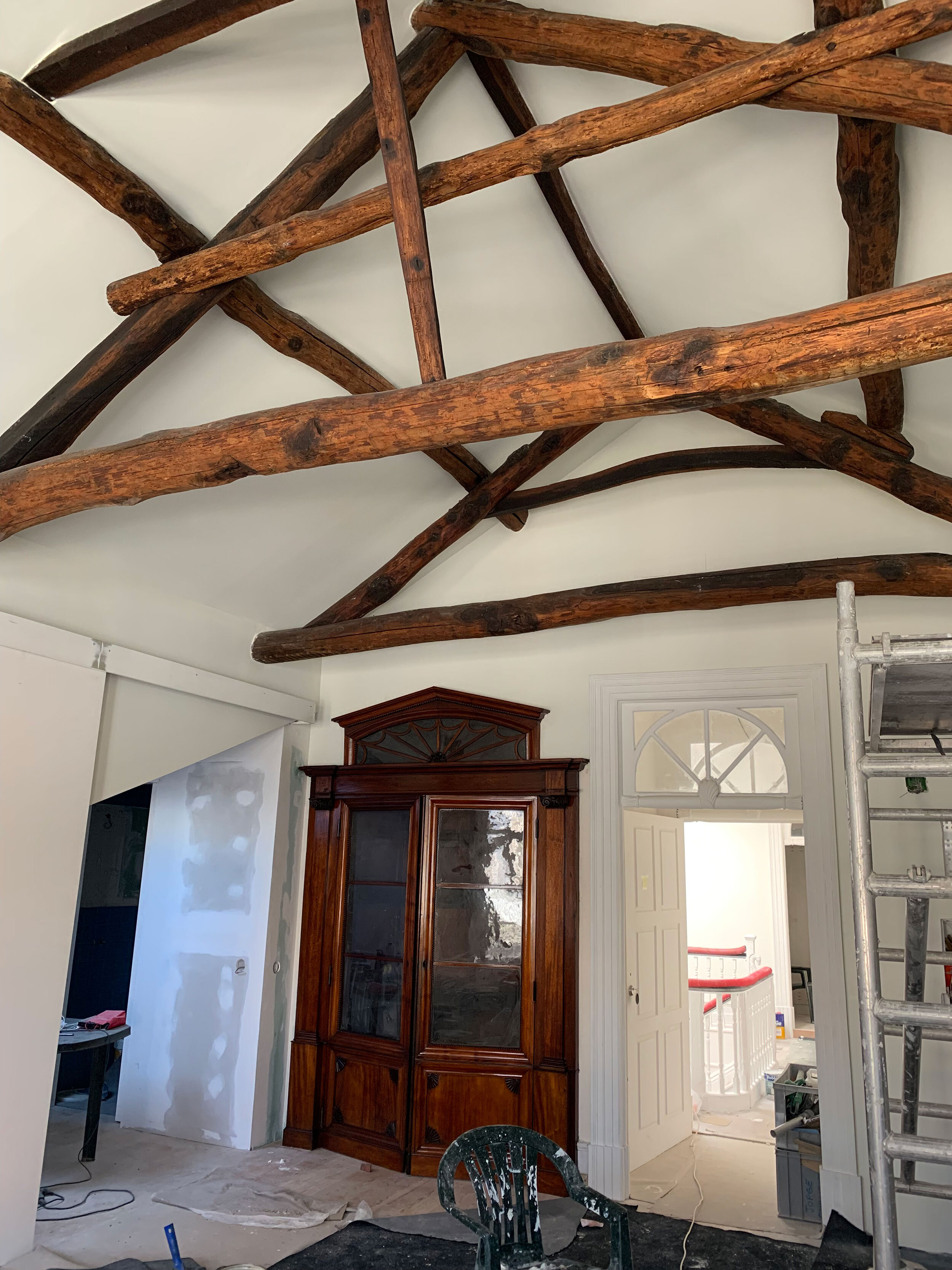 Preserved chestnut beams and restored piano role closet , now an office