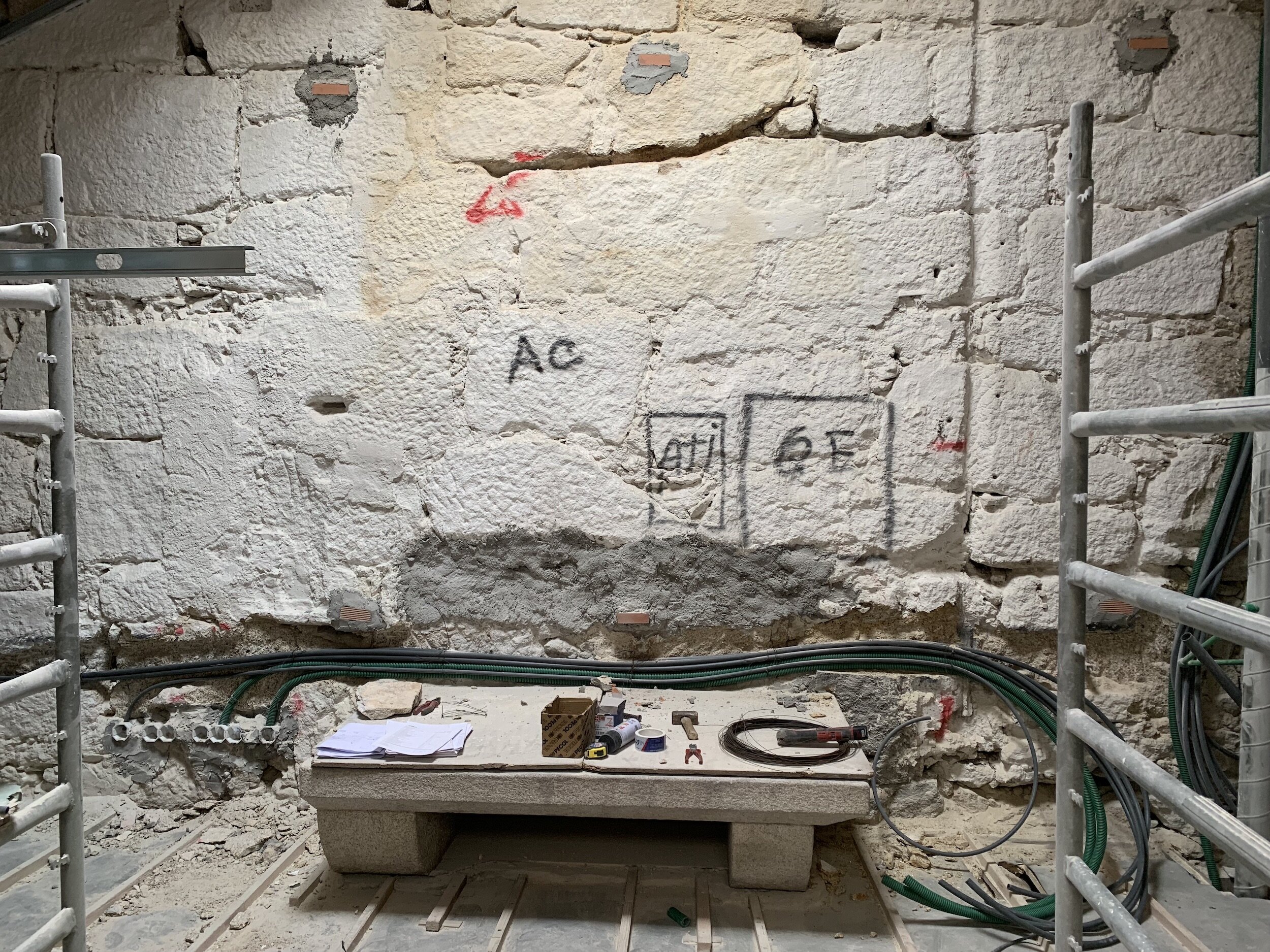 Establishing electrical positions in Apartment G wall over the antique granite hearth