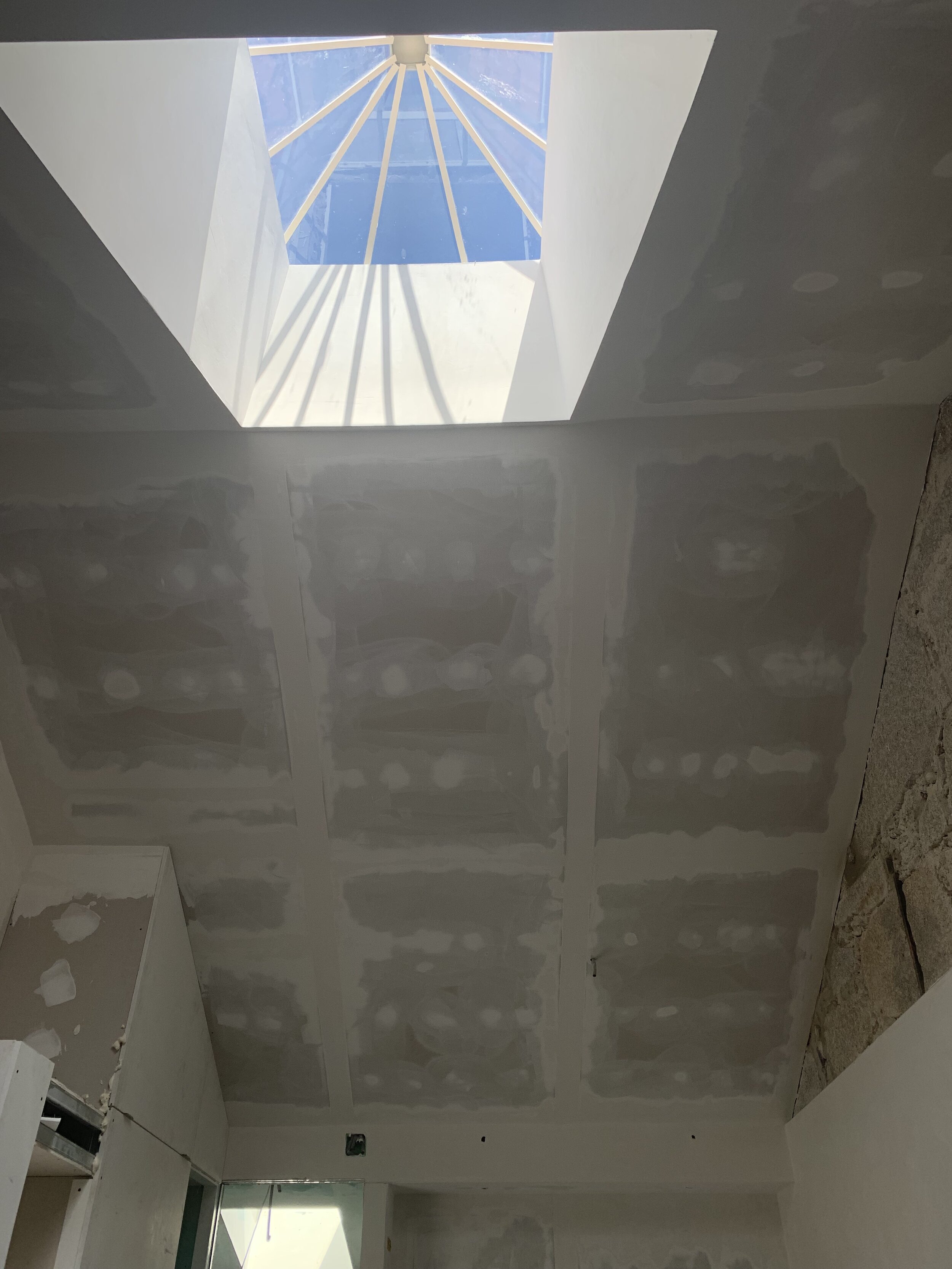 Looking up to the height of the skylight in Apartment G