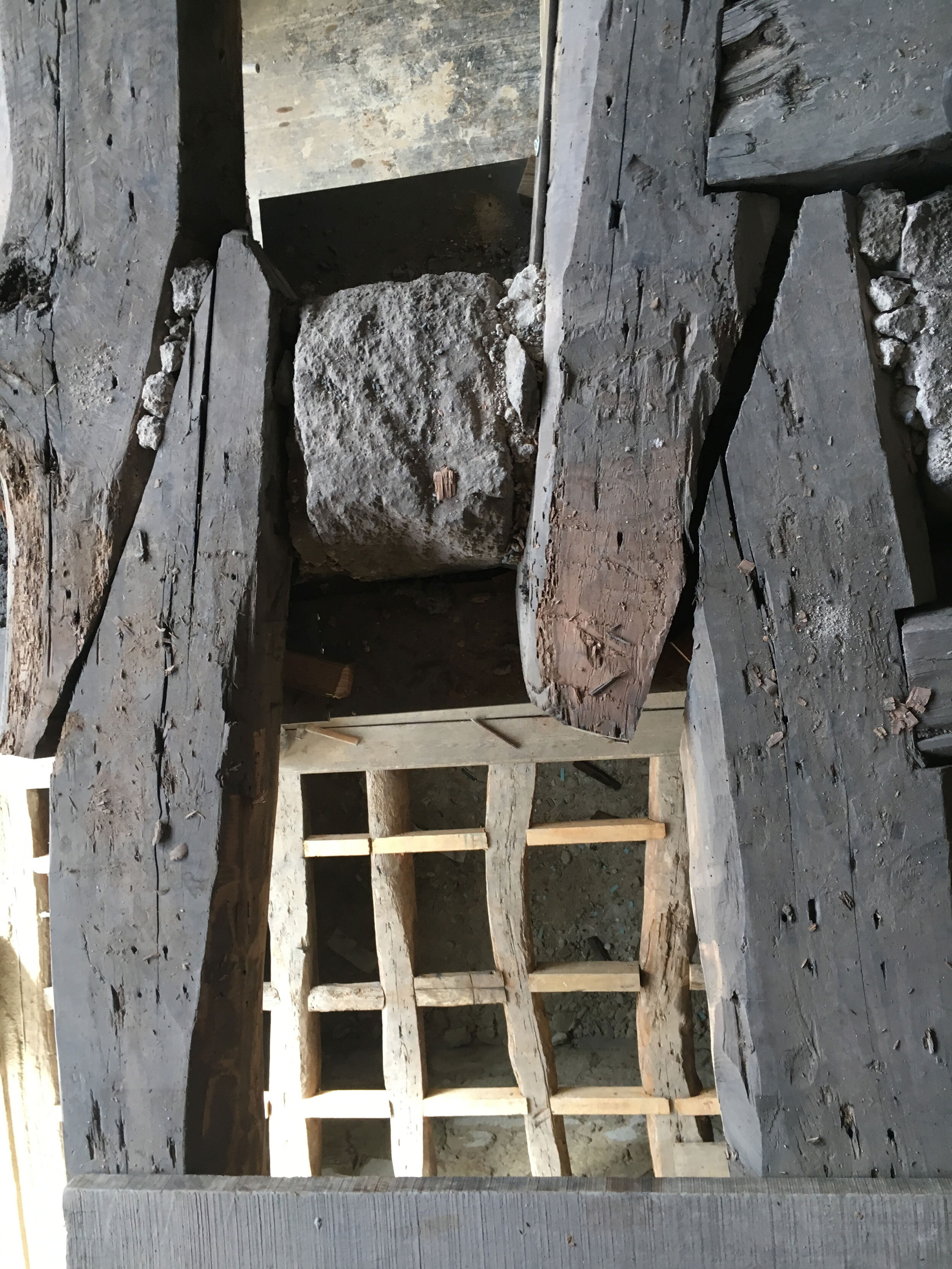 Sistering of massive joists resting on the granite bearing wall in the floor of Apartment D