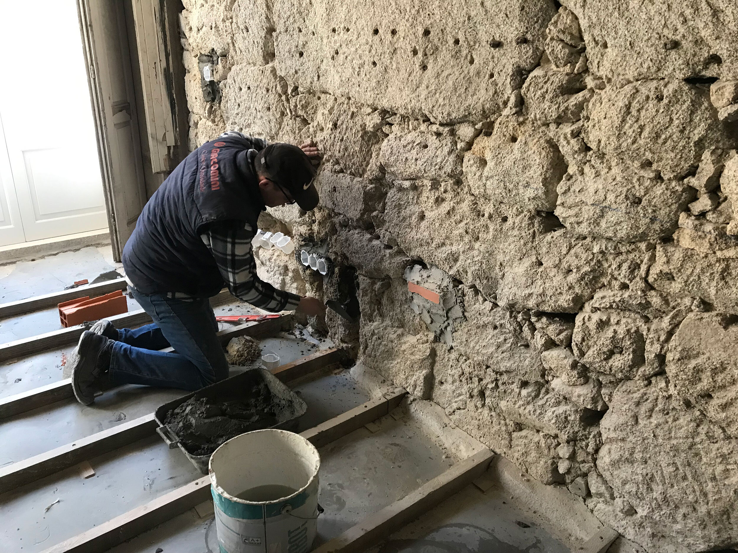 Preparing electrical boxes in Apartment D with brick noting the future plaster layer