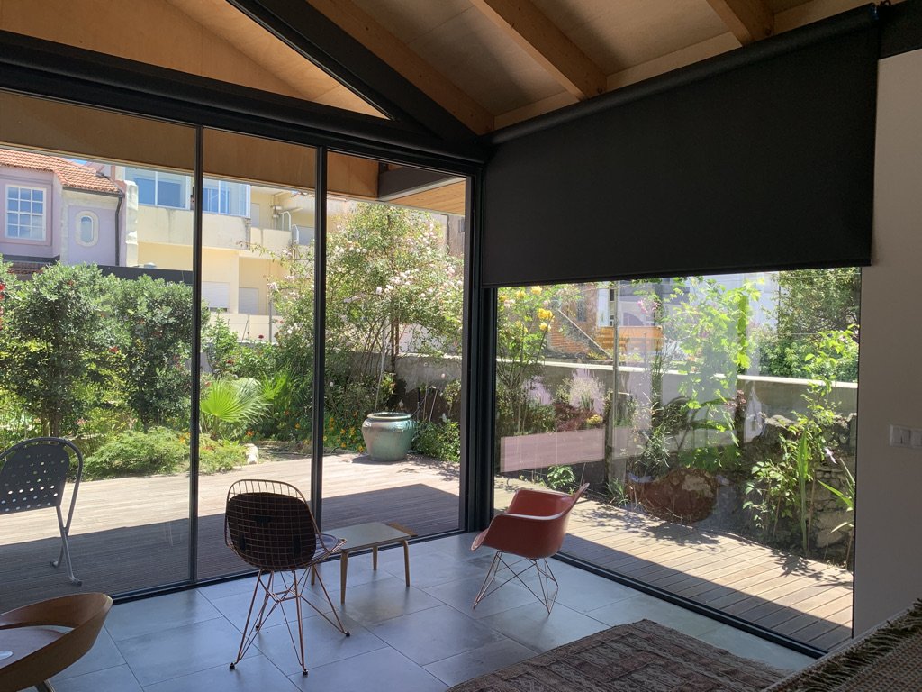  Looking out into the garden and veranda under the partly drawn privacy curtain. 