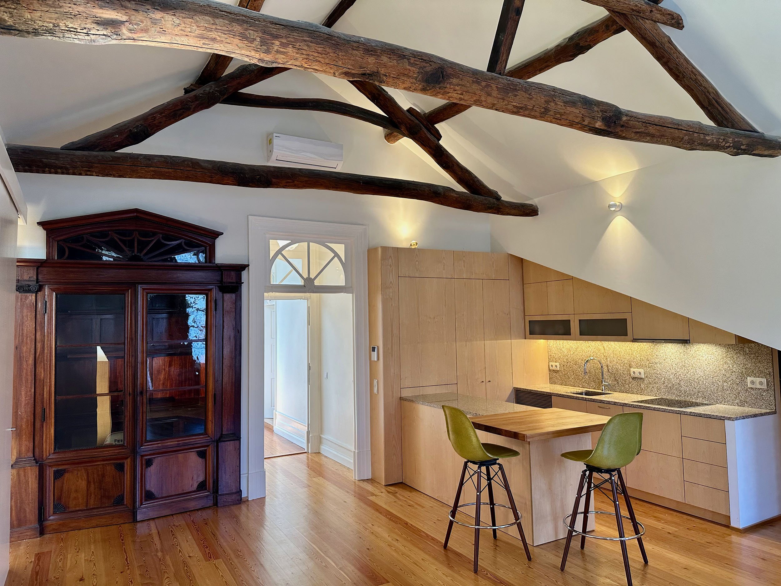   View of entry way, writing cabinet and kitchen  