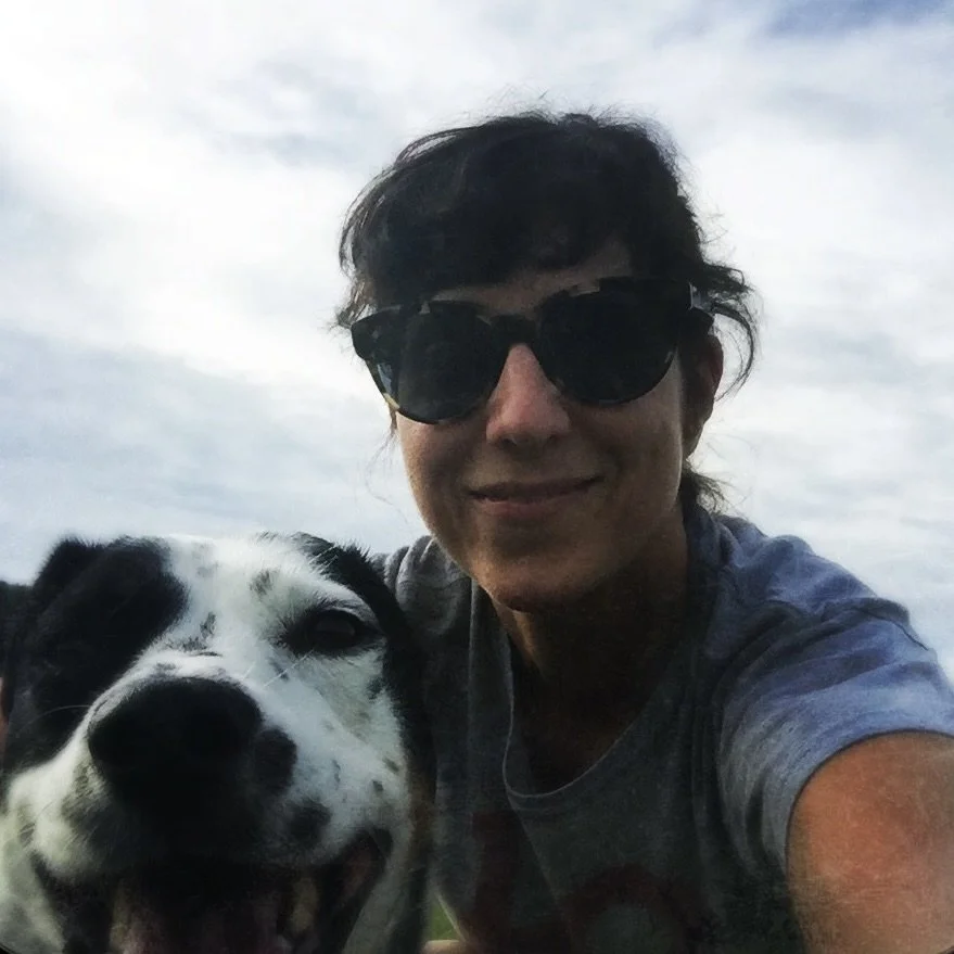 A black and white dog smiling at the camera with the person who loves him most.