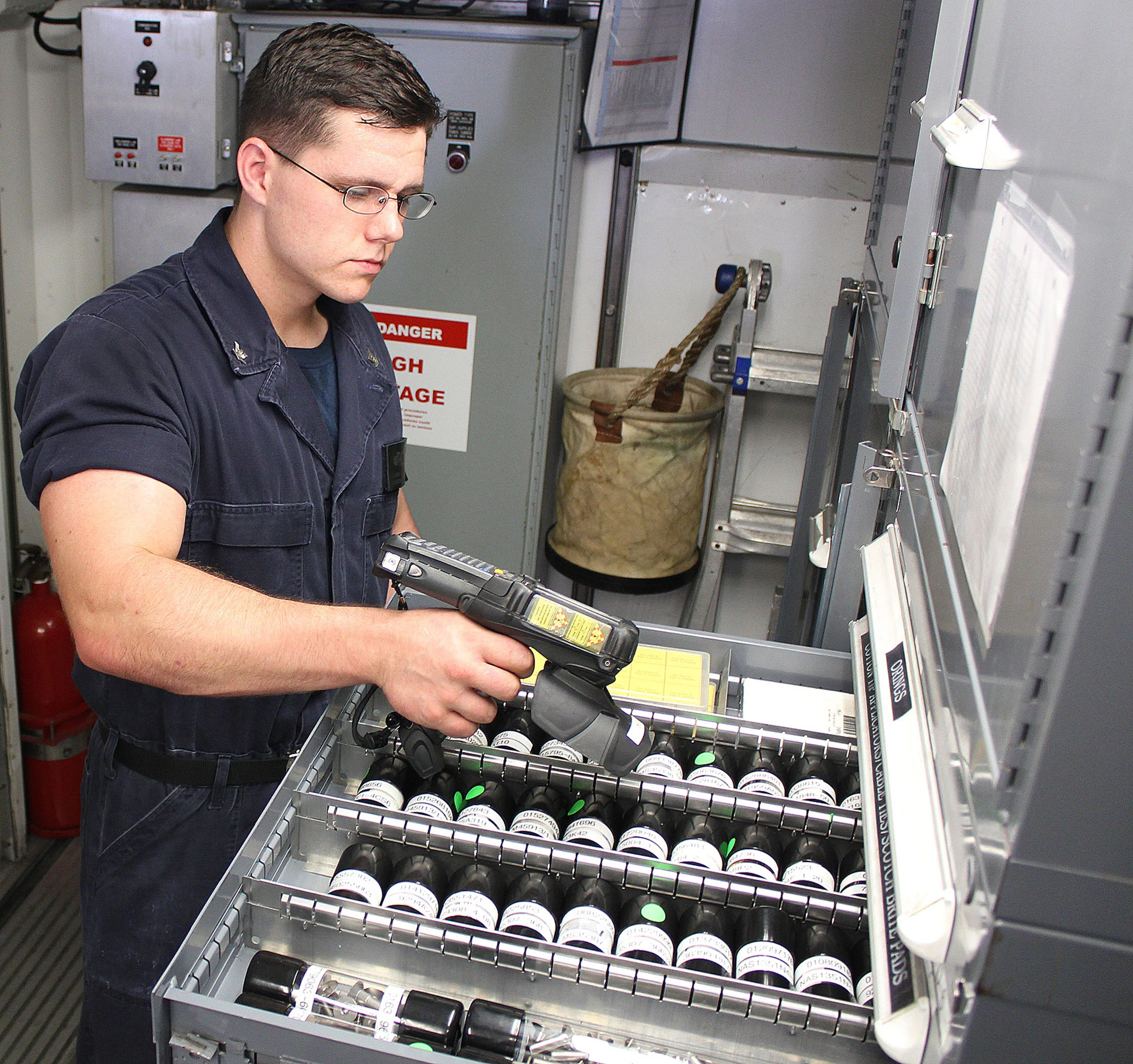 Pensacola, Florida - PENSACOLA, Florida - Machinist Mate Third Class Petty Officer (SW) Logan Peters uses a hand-held RFID scanner to conduct inventory aboard USS Independence. RFID technology provides the ability to dramatically reduce the time sailors spend conducting parts and equipment inventory in support of ship replenishment. (Photo : Katherine Mapp, U.S. Navy/Released)