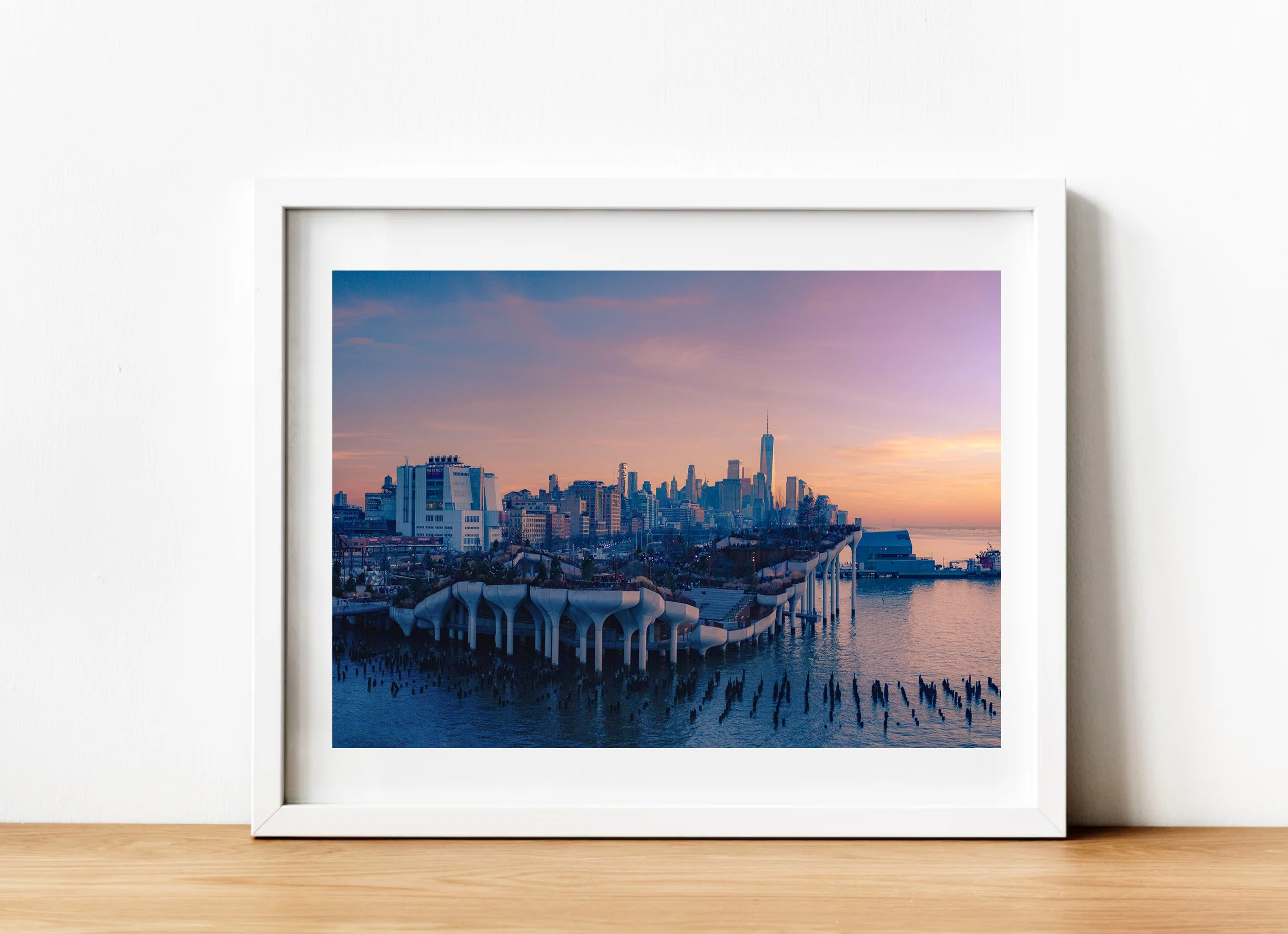 Fine art photograph of Little Island in New York City at sunset, showing the distinctive sculptural waterfront park architecture against the Manhattan skyline and evening sky.