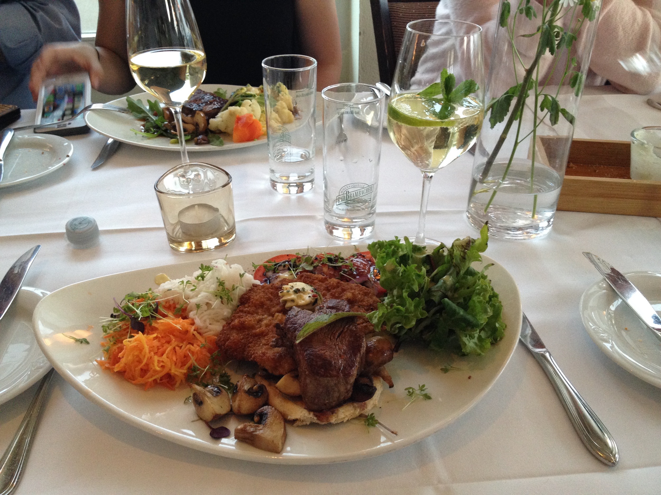  Schnitzel, pork medallions, mushrooms, and sauerkraut,&nbsp;with a Hugo&nbsp;(elderflower cocktail) to drink. 