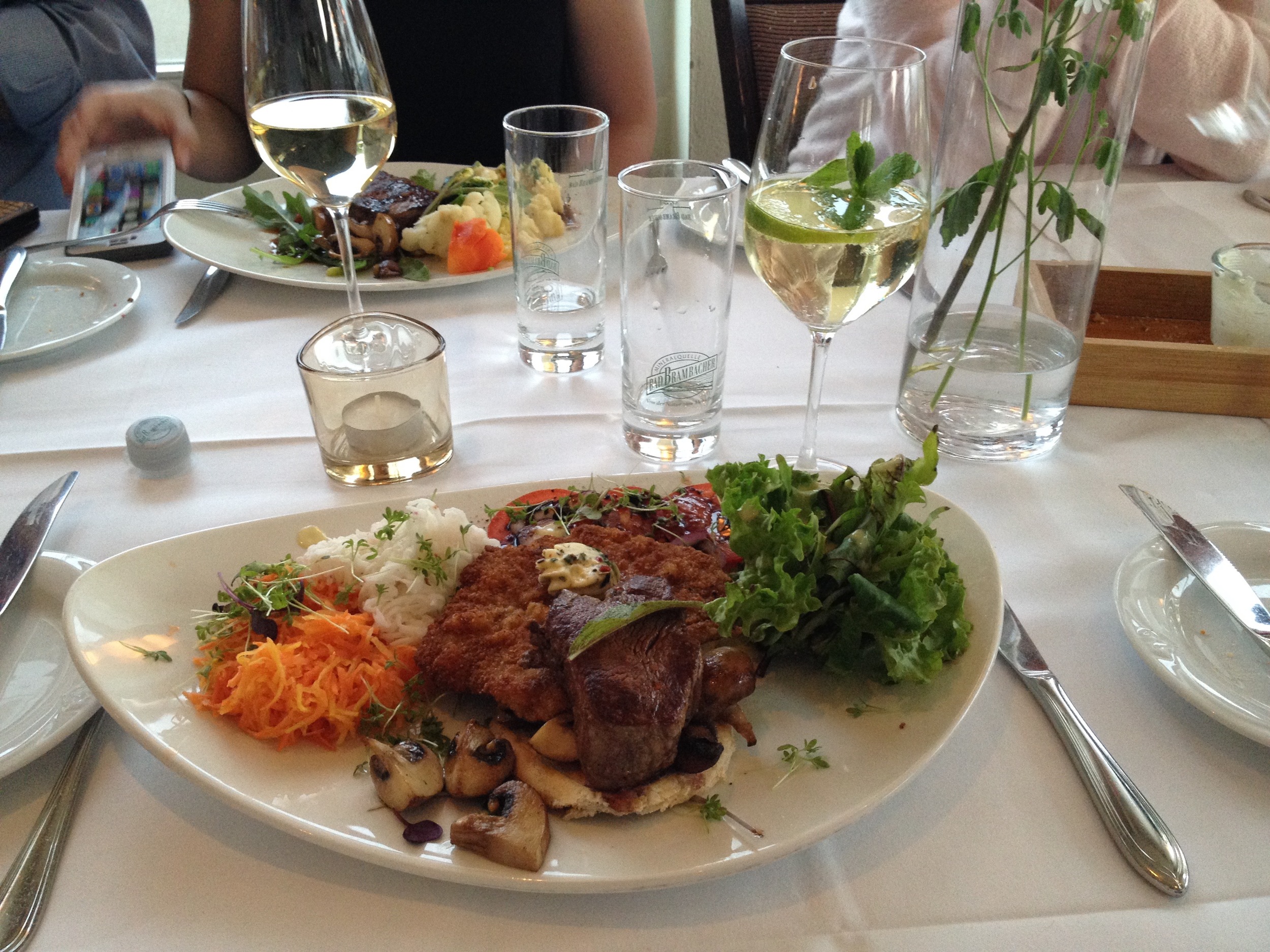 Schnitzel, pork medallions, mushrooms, and sauerkraut, with a Hugo (elderflower cocktail) to drink.