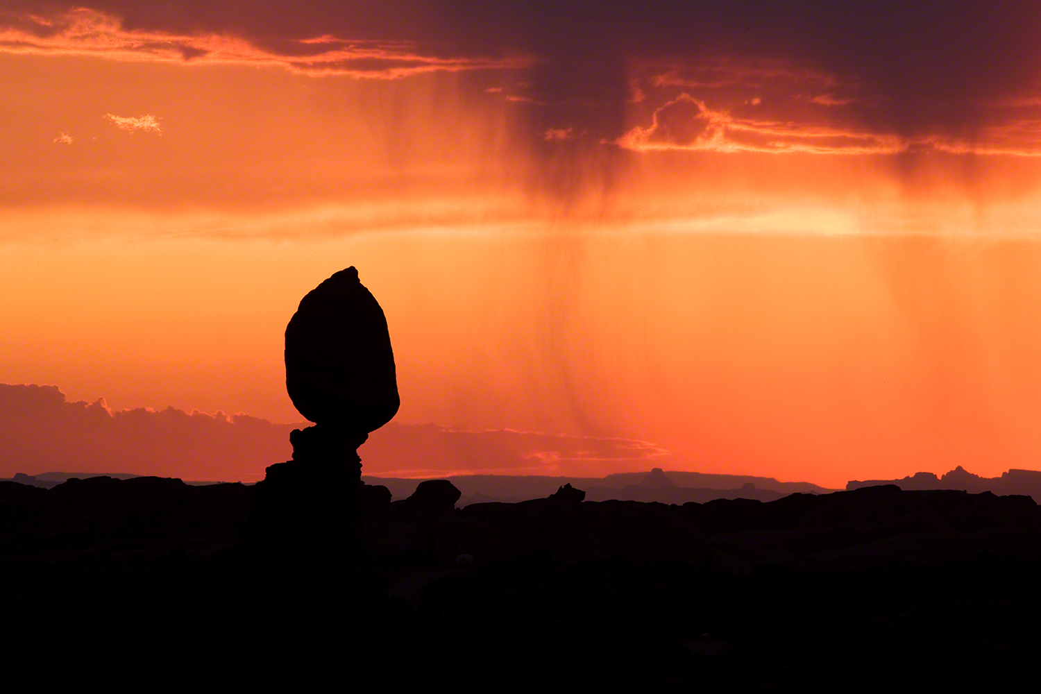 Balanced Rock With Rain At Sunset