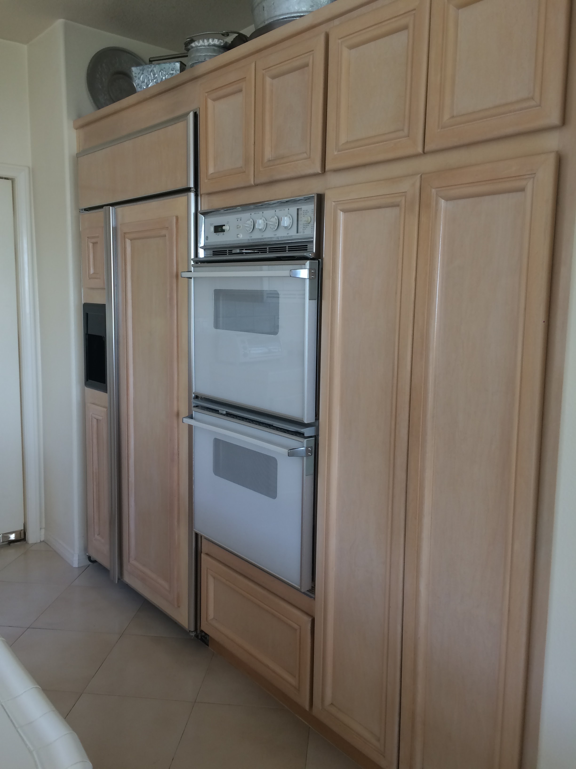 Stripping and restraining all cabinets throughout house. All new counter tops of white Dekton and light colored stone.