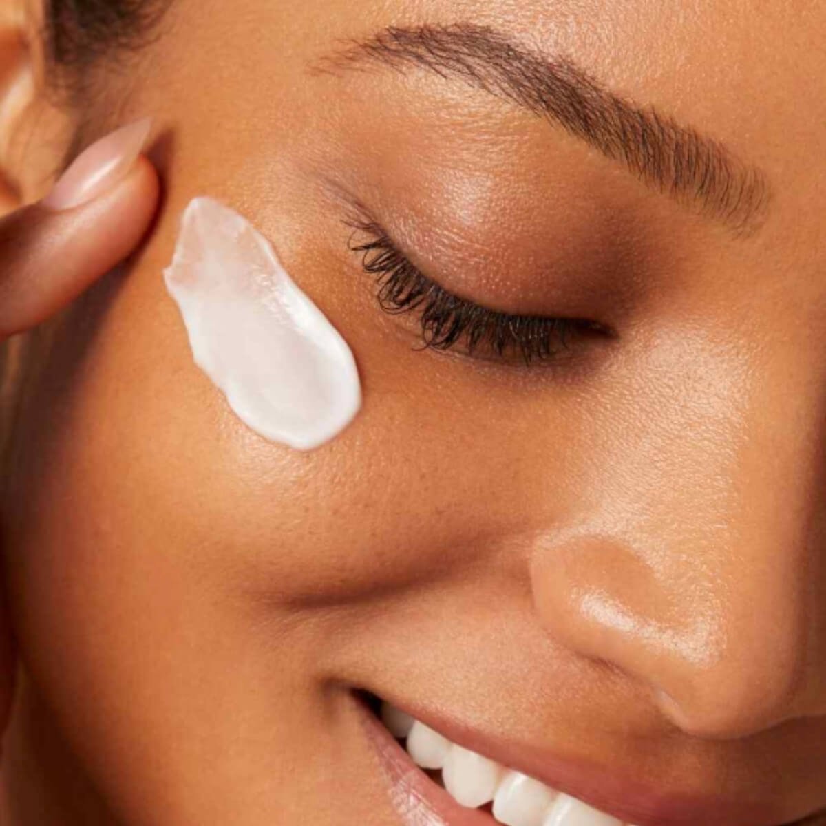 Woman with skincare on cheek