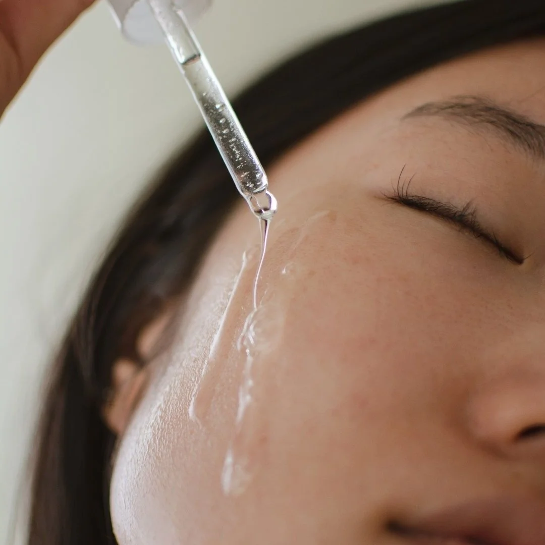 Skincare serum on face