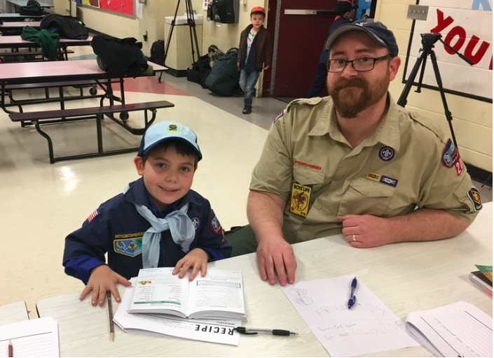 9-year-old Joe Maldonado with Pack 87 Cub Scout leader. 