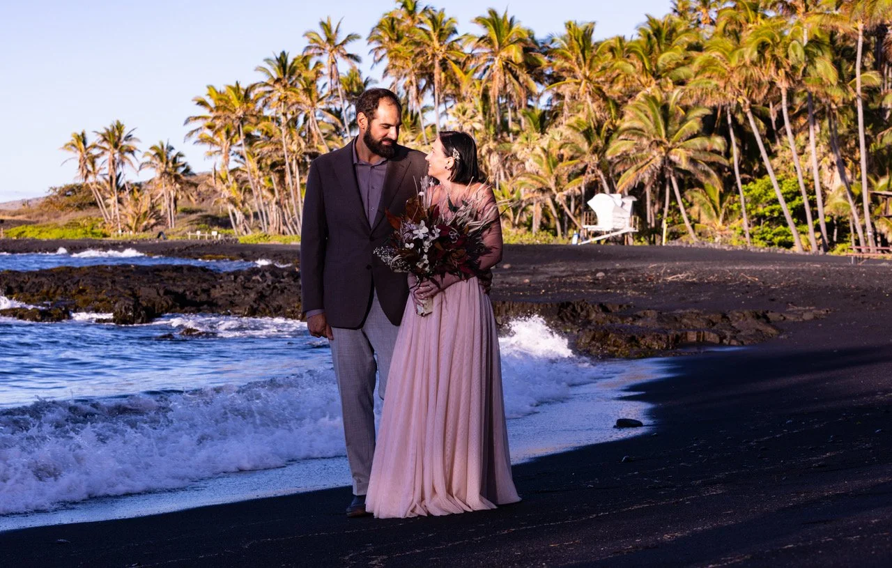 Wedding couple walking at shoreline at Wedding ceremony at Punalu'u Black Sand Beach