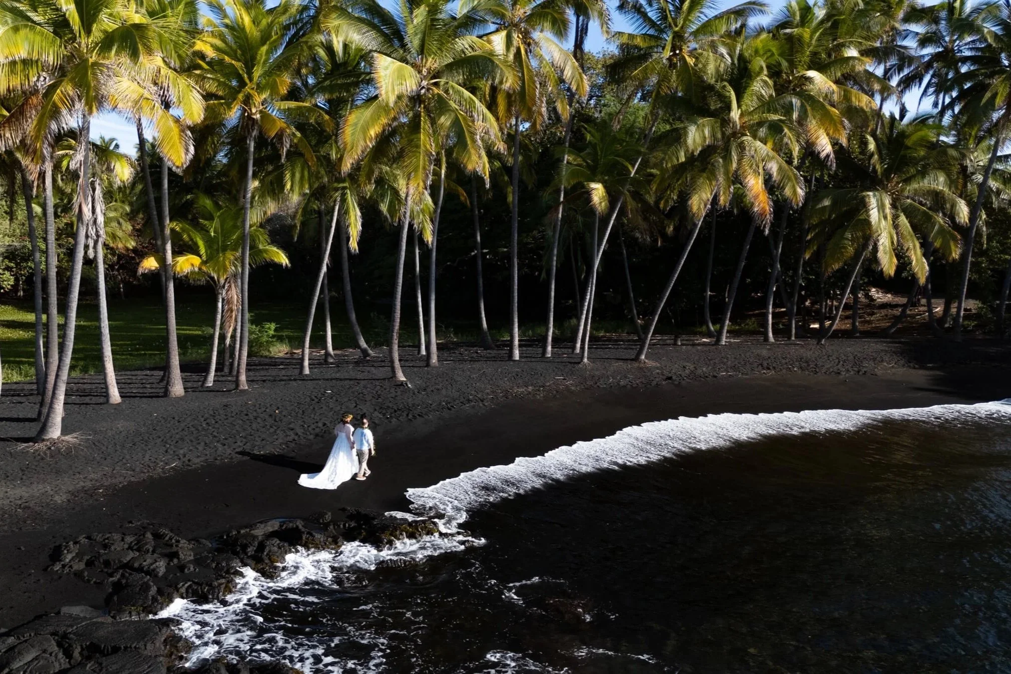 Drone shot of Couple walking at Black Sand Beach