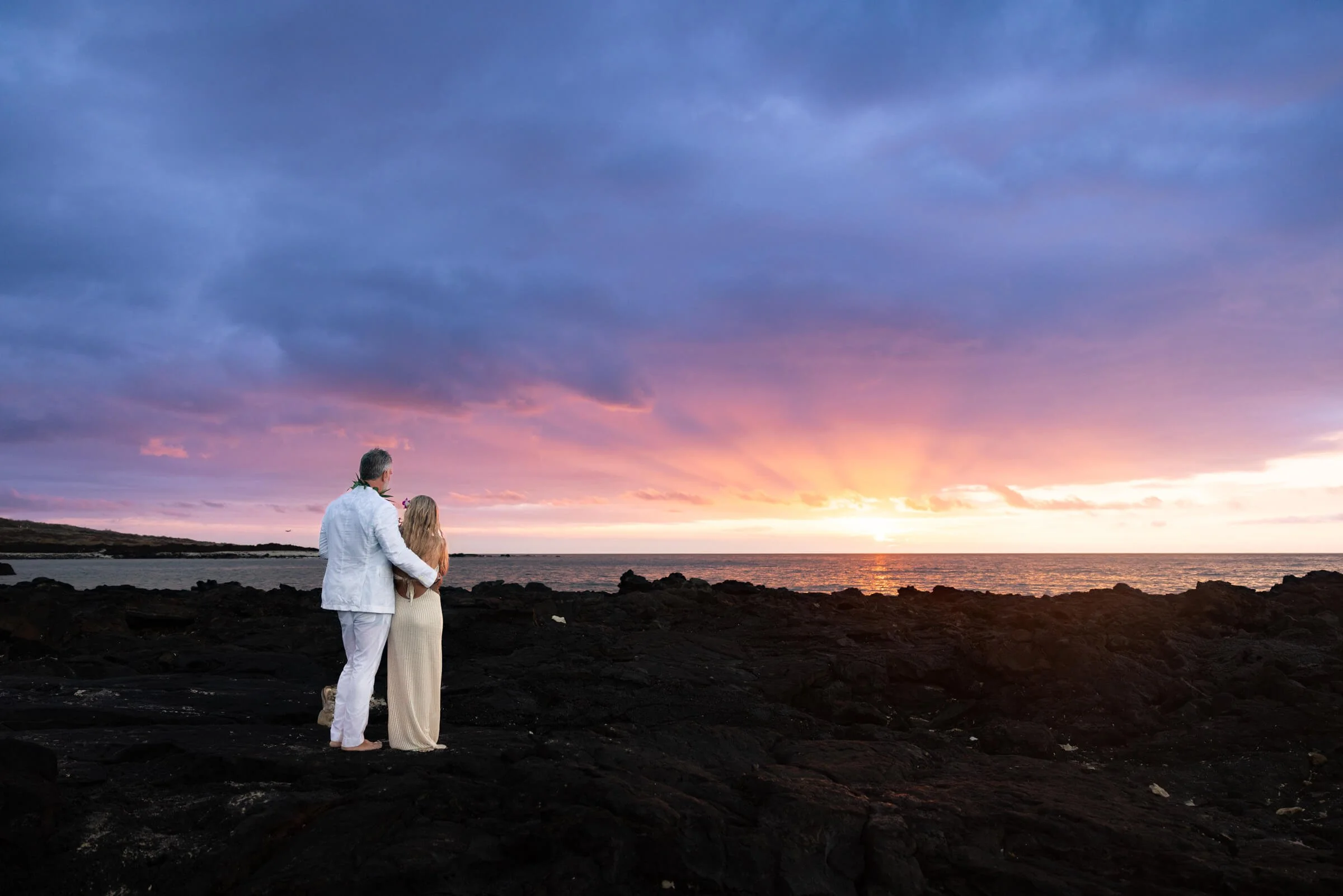 Couple watching the sunset after their elopement at the beach