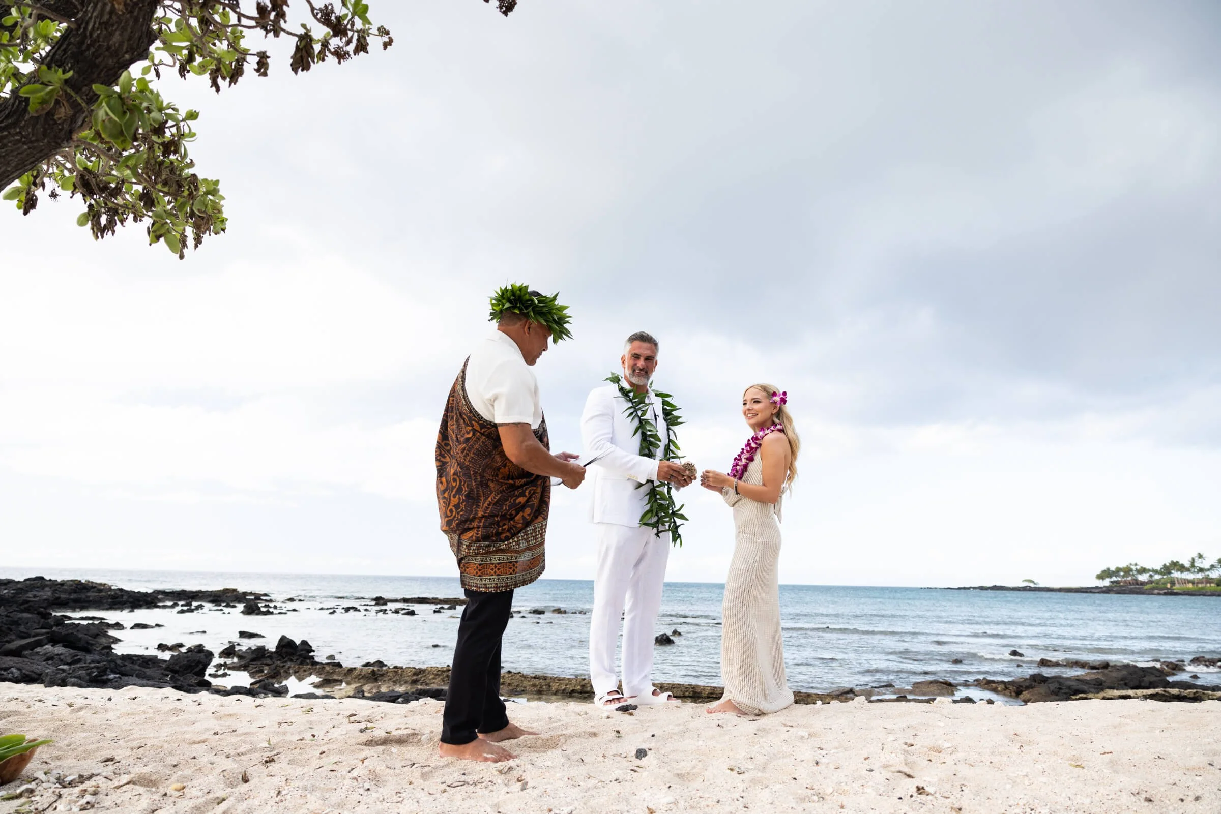 Hawaiian Officiant performs wedding ceremony at the beach on the Big Island