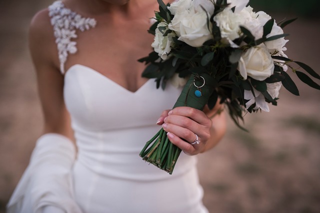 This photo of my bouquet has my grandma’s earring who has passed away and my mum’s original wedding ring so they were together and with me walking down the aisle. These precious family inclusions also formed part of my 'something borrowed, old and blue'.