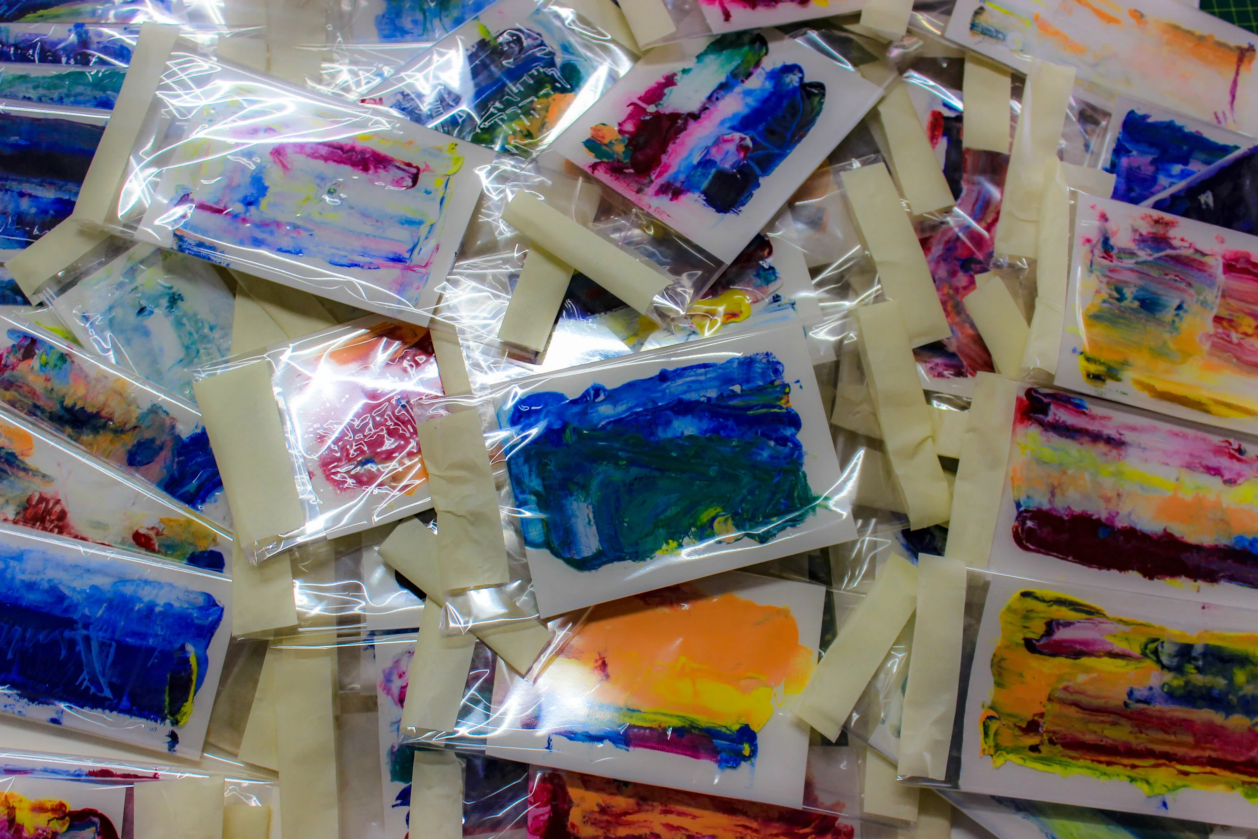 A pile of freshly wrapped (still wet) postcards, ready to begin their journey through the postal service system. 
