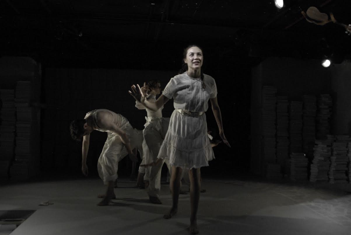 Alice (Sydney Lemmon) and cast members of Alice in Wonderland