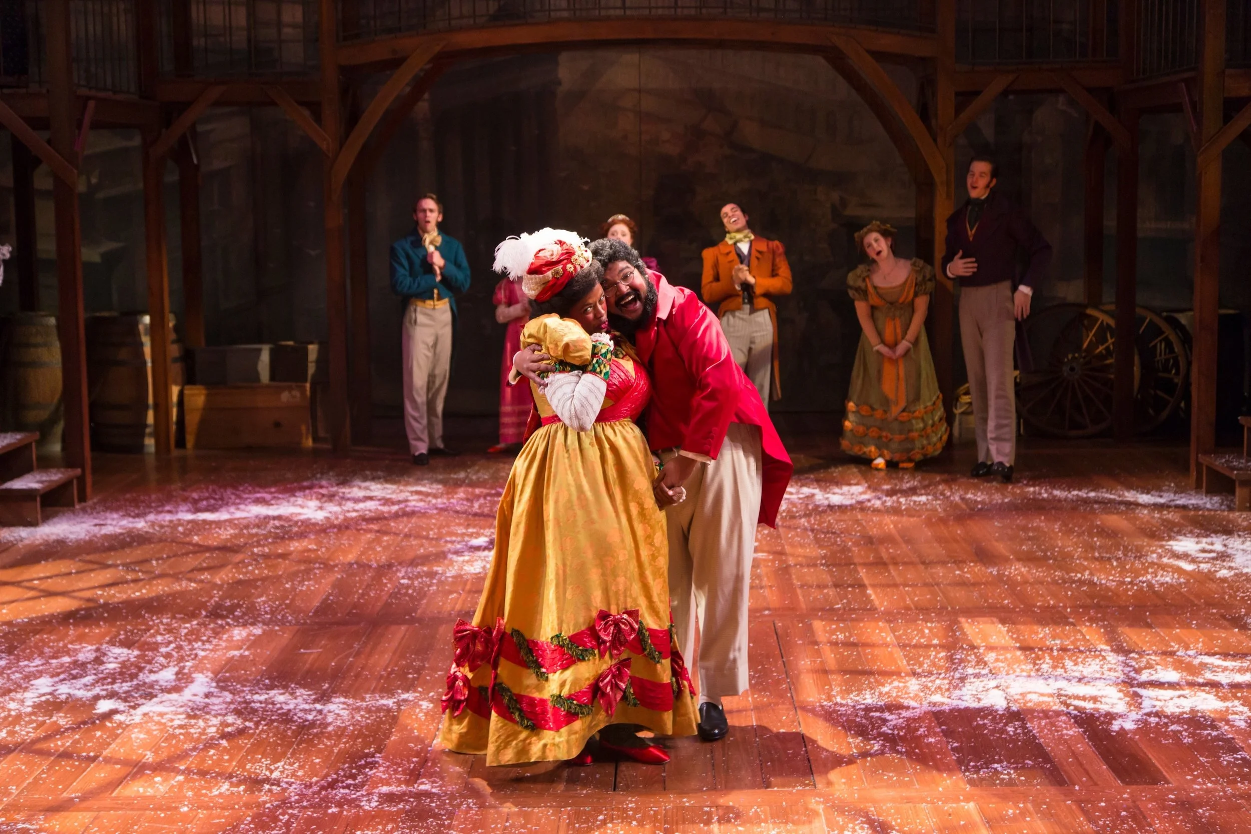 Mrs. and Mr. Fezziwig (Shauna Miles and Kenneth De Abrew) and cast