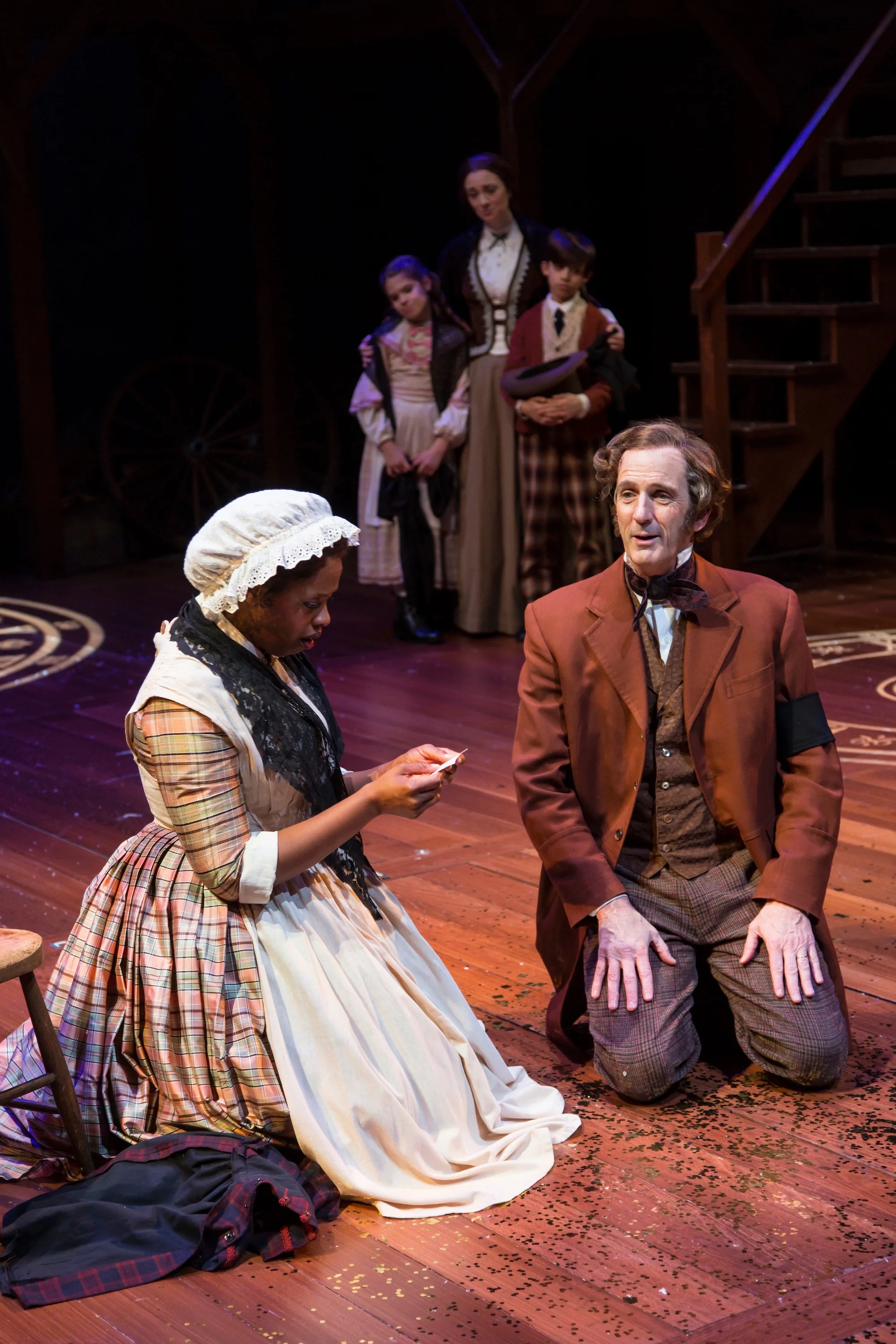 Mrs. Cratchit (Shauna Miles), Mr. Cratchit (Robert Hannon Davis) and cast